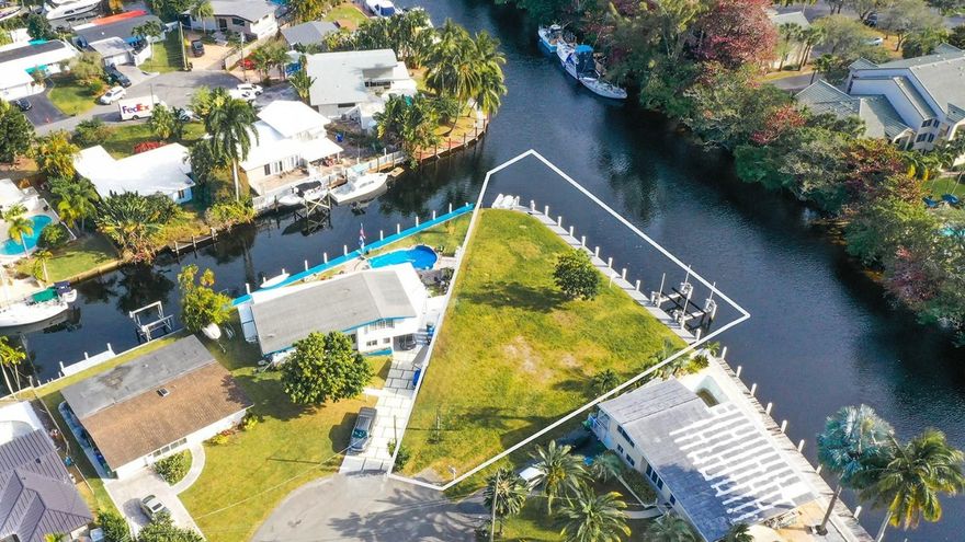 Paradise awaits in this Sought  after Lauderdale Isles  community This is a premium point corner lot! Situated along the picturesque deep New River, this exceptional point lot offers nearly 120 feet of prime waterfront and  is a quarter acre with a brand new 40 FT. dock , built in 2022.  This location is perfect for  boating enthusiasts, who want to build their dream home!  Did I mention, NO FIXED BRIDGES!  Thats right, No FIXED BRIDGES. Enjoy the peace and tranquility of a boaters life combined with easy access to all major highways, shopping, dining and more. Minutes to downtown and the Ft. Lauderdale Hollywood airport.