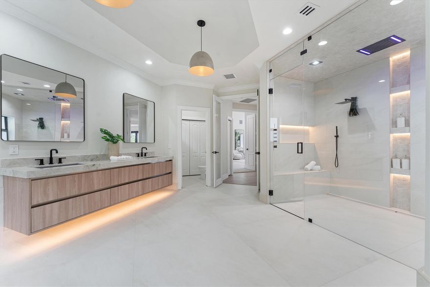 Opulence living in this completely updated estate boasting over 6,000 sq ft of modern elegance that blends luxury, privacy, and resort-style living at its finest. Spacious floor plan has 5beds/5baths + loft + large bonus/game room perfect for entertaining. Every detail has been thoughtfully designed showcasing new modern finishes, impact windows/doors, spa-inspired bathrooms, and a high-end chef’s kitchen w/ premium cabinetry & appliances. Primary suite located downstairs & includes a stunning closet & over-sized steam shower. Backyard paradise w/ long lake views, this outdoor living space has been elevated for all your wants & needs that includes  summer kitchen, huge marble deck, lagoon-style pool, pickleball/basketball court, putting & chipping green, lush landscaping & more.