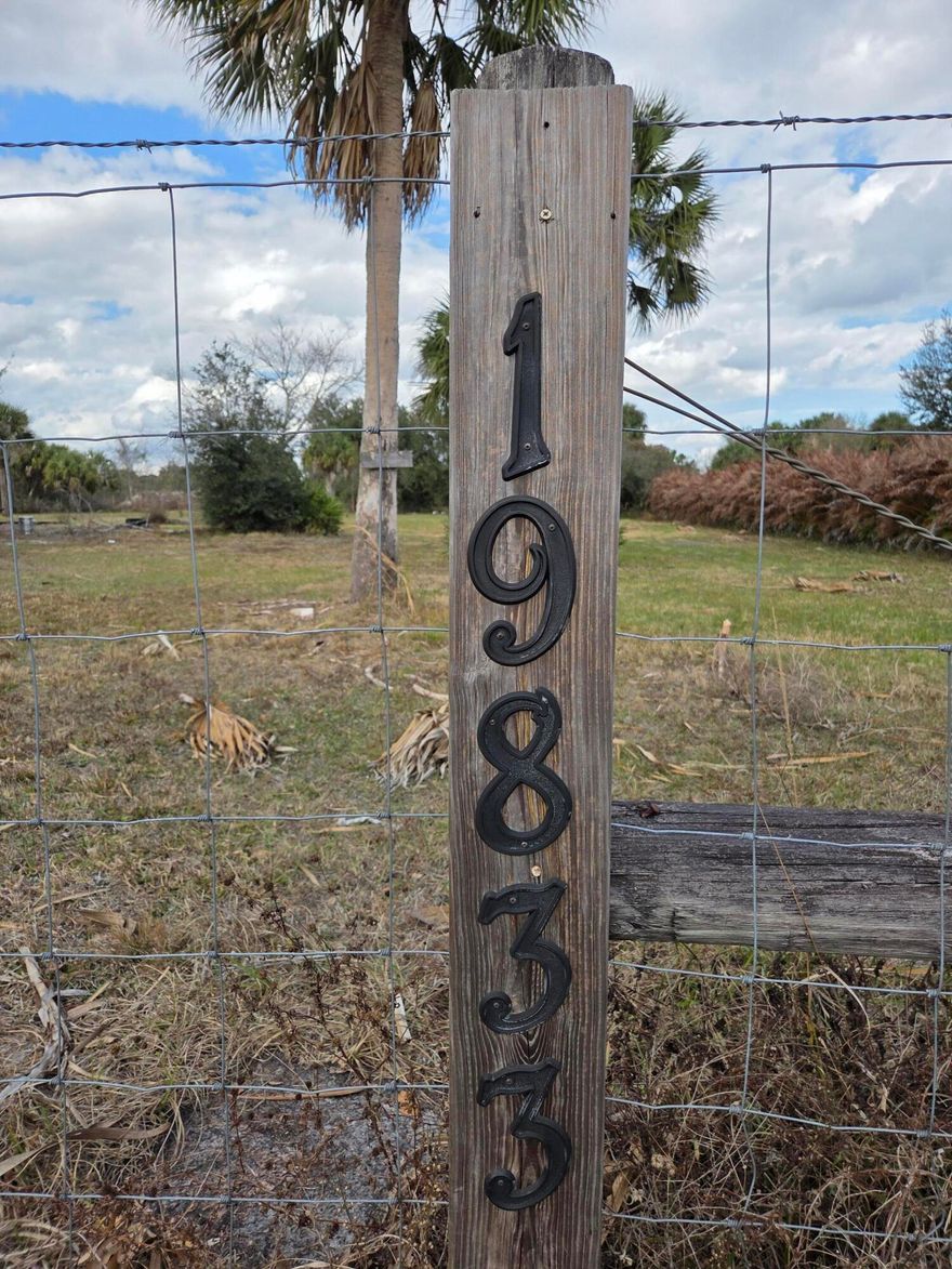 Electircity and Well already on this lot. Current county rules requires a home before getting these now. High and Dry!! Property has a culvert/driveway in place. Gently cleared leaving several trees near the road for shade. Fully fenced and gated.  Carport has paver tiles under and surrounding it, along with fire pit. Extra pavers under the trees. Berm at back corner. Build your own home or place a manufactured home here. Enjoy the privacy on the Prairie! The Kissimmee Prairie Preserve just down the road noted for Best Night time Sky views in the state. Wildlife in the area!  Room for  your garden, allowing you to live off the land if you want.