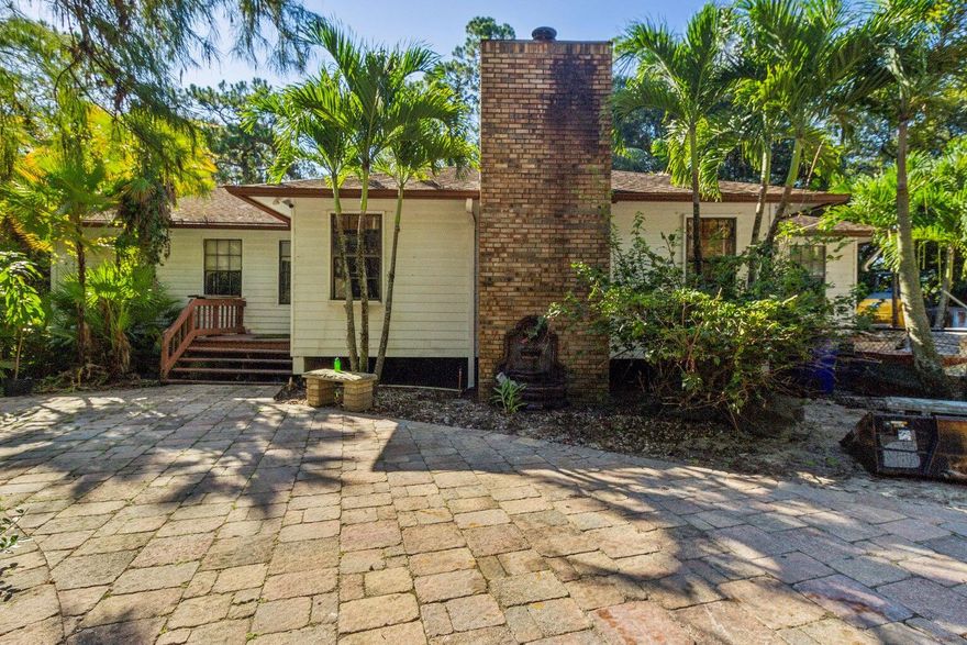 Prime corner lot in Loxahatchee offering excellent visibility and accessibility!  Just six blocks from Southern Blvd off of Seminole Prat Whitney Road. Ideal for farming, plant nursery operations and/or landscaping business. This property features a spacious home with 3 bedrooms 2 bathrooms with split floor plan, formal living room with brick fireplace, large kitchen, detached 2 car garage and extra building for more storage that can be converted into a guest house. Offers opportunity for renovation and customization. With no HOA the possibilities are endless!!!
Professional photos coming soon!