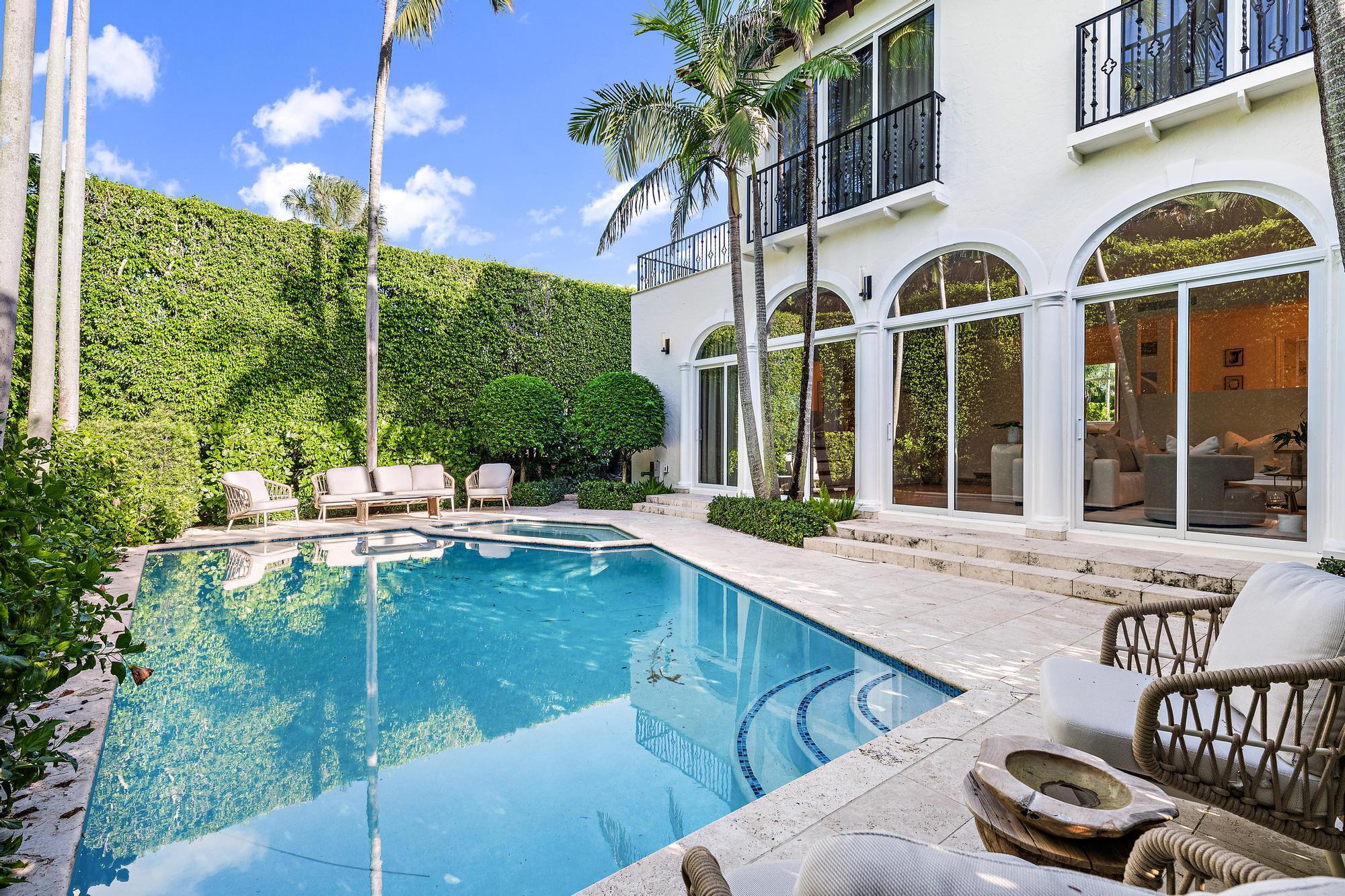 Featuring a rare CLAY TENNIS COURT and sunsets over an OLYMPIC-SIZE LAP POOL on the Intracoastal, 245 Everglade Ave, a 3 BR/3.5 BA 4,416 SF Townhouse, is fully reimagined in the most WALKABLE neighborhood steps from the beach, Lake Trail, Places of Worship, Amici, Lola, PB Grille, Sant Ambroeus, Trevini & more. Elevated at 10.9' (4' ABOVE FLOOD), it offers bright, airy interiors, a PRIVATE POOL/SPA & ELEVATOR. The main floor features HIGH CEILINGS, WOOD FLOORS, and a chef's kitchen with SUBZERO/WOLF & MARBLE. The top floor offers a PRIVATE PRIMARY SUITE with 2 WALK-IN CLOSETS, 2 TOTO WASHLET ROOMS, sitting room, SPA-LIKE MARBLE, BALCONY OVER POOL, and SUNLIT TERRACE. New IMPACT WINDOWS/DOORS/GARAGE, NEW ROOF, GENERATOR, and high-end finishes offer TURN-KEY living. 1 YEAR WARRANTY INCLUDED