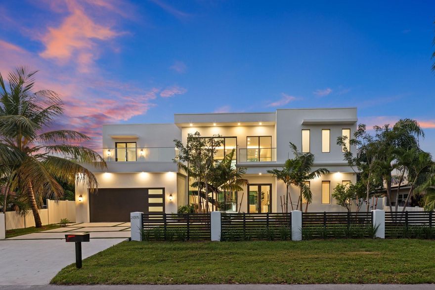 Modern elegance & architectural sophistication define this Wilton Manors home spanning 3,755 SQFT with 4BD, 4.5BA, & 2-CG. Featuring a floating glass staircase, private elevator, and soaring 24’ ceilings, Filled with natural light throughout its open design. Italkraft cabinetry, quartz countertops, Miele appliances, and wine cooler complement the sleek interior. Two identical primary suites—one on main level & additional upstairs—plus two guest bedrooms connected by an enclosed glass catwalk overlooking the living area. Additional features include prewired sound system, stackable washer/dryer upstairs, full laundry room on main level, surrounded by tropical landscaping with an outdoor kitchen, saltwater spa and lap pool with waterfall feature. Designed & Built by Atlantic Group Developers.