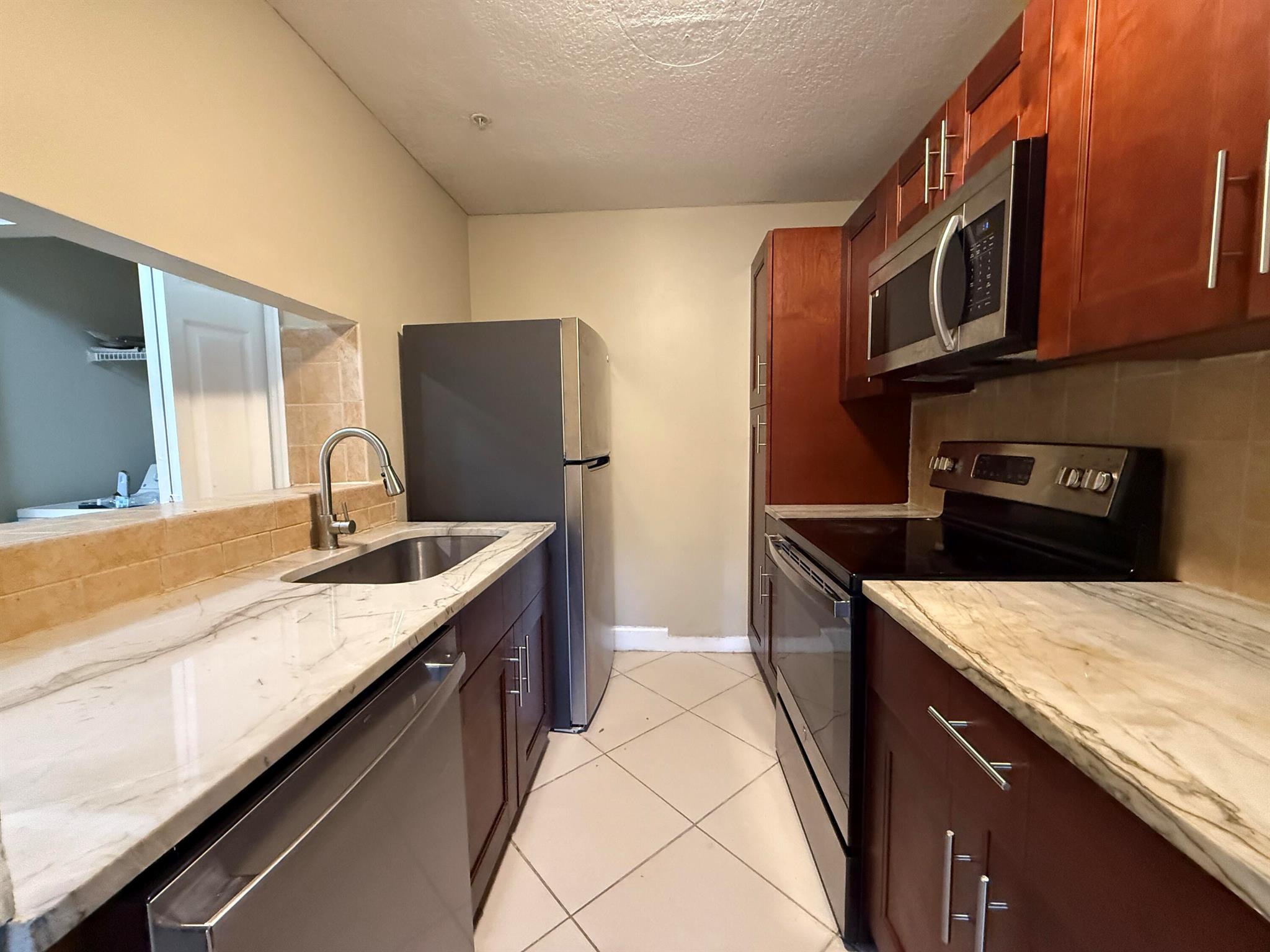 Discover comfort in this 2-bed, 1-bath 1st-floor unit in Boynton Landings, a gated community in the heart of Boynton Beach. The living room boasts elegant tile flooring, while new laminateflooring graces the bedrooms. Revel in the modern kitchen with new cabinets, granite countertops, and newer stainless-steel appliances. This residence offers a fresh and stylish living experience. Convenientlylocated near major roads, including I-95, this home is perfect for those seeking both comfort and accessibility