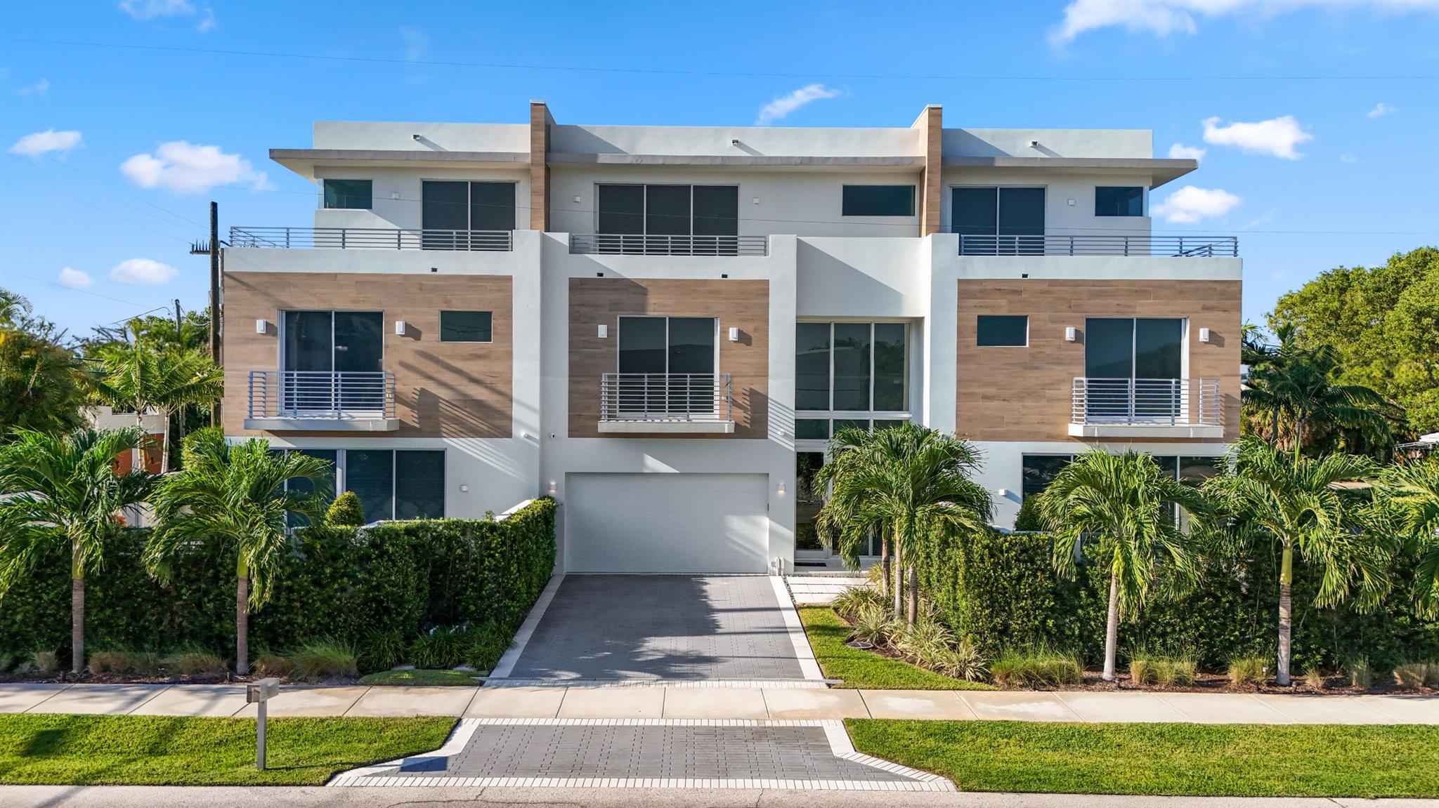 Modern Luxury Meets Coastal Living in the Heart of Delray Beach. Ideally situated just two blocks north of vibrant Atlantic Avenue and steps from the charm of Pineapple Grove, this exceptional residence offers walkable access to Delray's finest dining, shopping, art galleries, and nightlife. And with the beach less than a mile away, your dream of coastal living is truly within reach. Completed in 2021, this masterfully designed home showcases three levels of impeccable craftsmanship, seamlessly blending industrial modern aesthetics with warm, refined finishes. Every square foot has been thoughtfully optimized -- featuring soaring ceilings, floor-to-ceiling glass, and an open layout that enhances light, flow, and function.