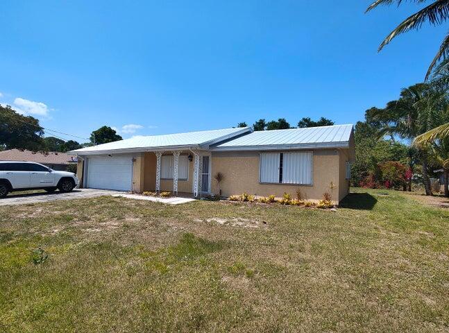 This house is priced to fit your budget. 2 bedroom 2 full bathroom house has a 3rd room that can be used as an additional bedroom or an office or a den. No Carpet. Screened and Covered Patio. Enough land in the back yard for a Pool, for kids and pets to play an to plant your Treea and Garden. No Homeowners Association. Centrally location in the city of Port St Lucie. Shopping and find dinning is only minutes away. House is move-in ready. The Water Heater, Garage Door and Air Condition were changed in 2020. The Metal Roof was replaced in 2023. Call today for an appointment to view and make it your own.The Seller will contribute $5,000.00 toward buyers closing costs and prepaids with a full price offer.