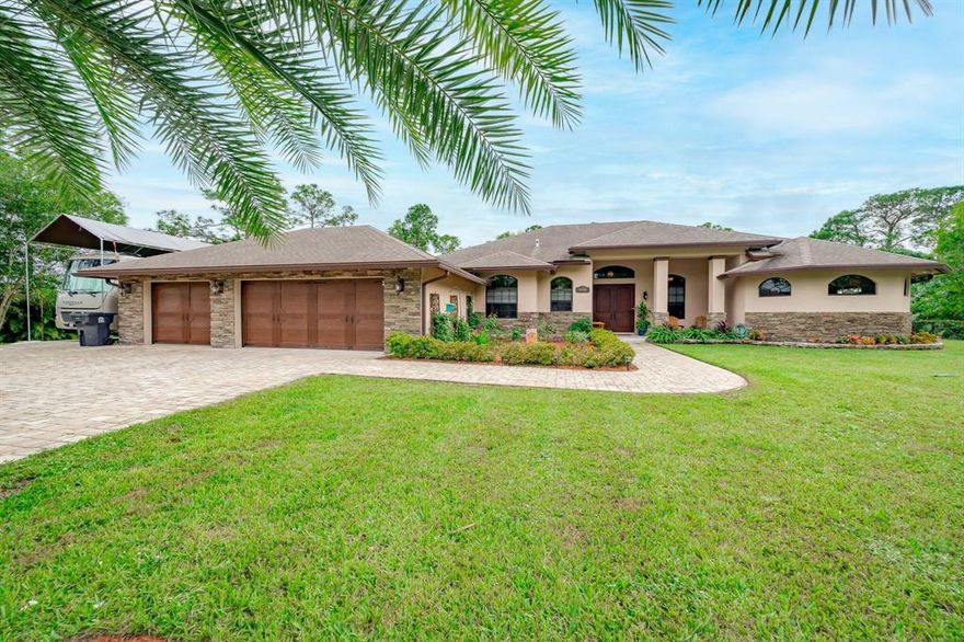 NO HOA*** 1.15 ACRES***  Incredible opportunity, totally custom built home everything is top of the line . Own your private Oasis fully fenced yard with electric gate, brick paver horseshoe driveway, 3 car garage, impact windows and doors, vaulted faux wood beams, gourmet chefs kitchen custom cabinetry hardwood island, barn doors, parlor doors, copper sinks, wood burning fireplace, stainless steel appliances, summer kitchen with grill and refrigerator, salt water pool with jacuzzi and rock waterfall. RV driveway with electric/ water hookup. Located only 1 house from paved road.  You have to see in person to appreciate the full scope of all the upgrades, don't miss this gem.