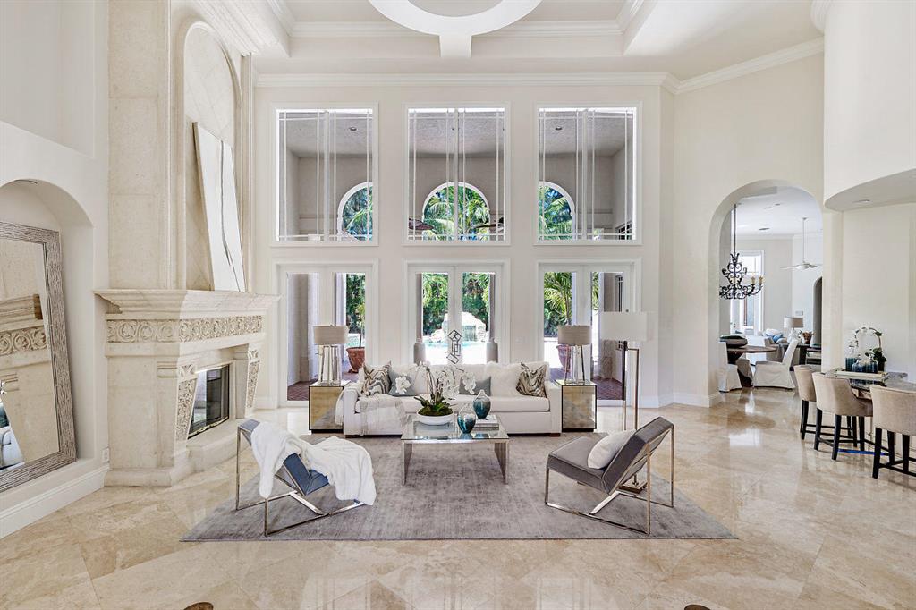 This exquisite and private estate boasts over 6500 square feet of luxury from floor to ceiling, located in the exclusive enclave Foxe Chase in Delray Beach. A rare opportunity to own a custom single level tri split home on a 1+ acre lot. Be wowed from the moment you enter with soaring coffered custom ceiling detail. Entertain in the formal living, dining space and bar. A true open concept and airy feel throughout. Home is well appointed with custom chefs kitchen, impact glass, 4 car garage. Desirable and functional floor plan with 6 suite sized bedrooms with en suite bathrooms, the master suite is oversized with custom his and her walk in closets and a sitting area.