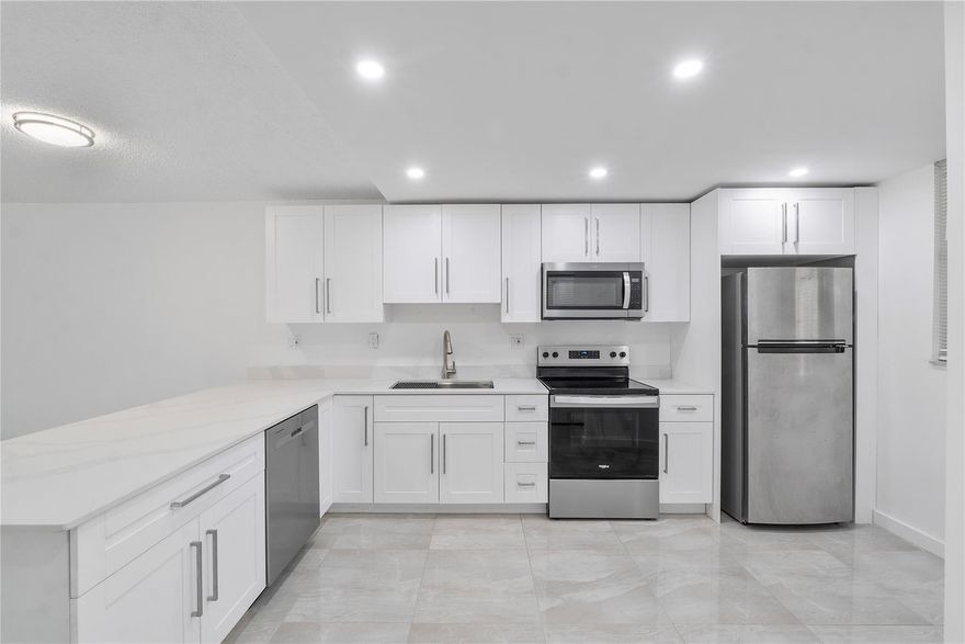 Stunning 2/2 55+ in Environ II in Lauderhill. Completely updated, open floor plan. New cabinets and appliances in your gourmet kitchen with luxurious Quartz counters and a new deep sink. The plumbing has been improved throughout. Upgraded ceramic tile throughout. Bathrooms have been updated with beautiful tile accents and vanities. High hat lighting. Freshly painted with upscale molding. Even the front door has been replaced! Huge patio to enjoy your morning coffee. Roll down shutters for extra protection. Water, cable, Internet, trash and pest control are all included in your HOA fee. Numerous activities to enjoy at the nearby clubhouse with a tennis court and pool conveniently located across from the building. All assessments have been paid for a new roof, pool & elevator