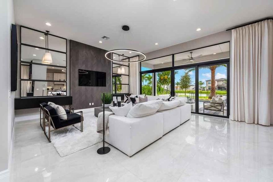 A beautifully appointed contemporary residence offering 4 spacious bedrooms, a generous loft, and a convertible media room that can easily serve as a 5th bedroom, complemented by 5 impeccably designed full bathrooms. 

This home features an open-concept great room seamlessly connecting a spacious kitchen and family dining area. The chef's kitchen is equipped with abundant cabinetry, an oversized island, and a custom range hood.

A thoughtfully crafted mudroom with built-in cabinetry is conveniently located off the three-car garage, along with additional storage beneath the staircase. Each bedroom includes its own en-suite bathroom for optimal comfort and privacy. The primary suite offers French doors leading to a large covered veranda with serene pool and lake views, along with dual primary bathrooms. The media room provides a dedicated entertainment space and can easily be converted into a 5th bedroom, with veranda access available from the loft.

Large sliding doors extend the living area to a covered patio off the family room, overlooking the inviting pool and picturesque lake.