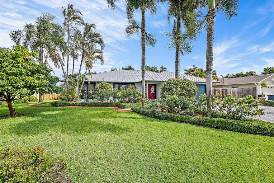 Welcome to Rocky Point, a desirable neighborhood with a marina nearby for the avid boater. Step inside to an open space with vaulted ceilings. The home features a split floor plan, with three bedrooms, two baths under 1,725 square feet of living space. Large, paved driveway with enough space for a boat or RV. Living areas have 8'' diagonal tiles, and the kitchen features cherry cabinets, stainless steel appliances, granite counter tops and a gas stove. The Primary Suite has a wide plank, distressed hardwood flooring, and the Primary Bath has his and her sinks, granite counter tops and a shower/jacuzzi tub. Relaxing outdoors is easy by your heated pool with plenty of privacy with lush, tropical landscaping and privacy fence. Conveniently located close to marinas, beaches, dining and shopping. Minutes from A1A, US-1, I-95 and Florida's Turnpike.