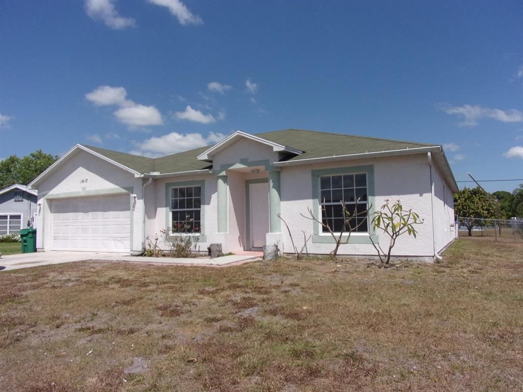 Photo of 1407 SE Grapeland Avenue, Port Saint Lucie, FL 34952 (MLS # R10706738)