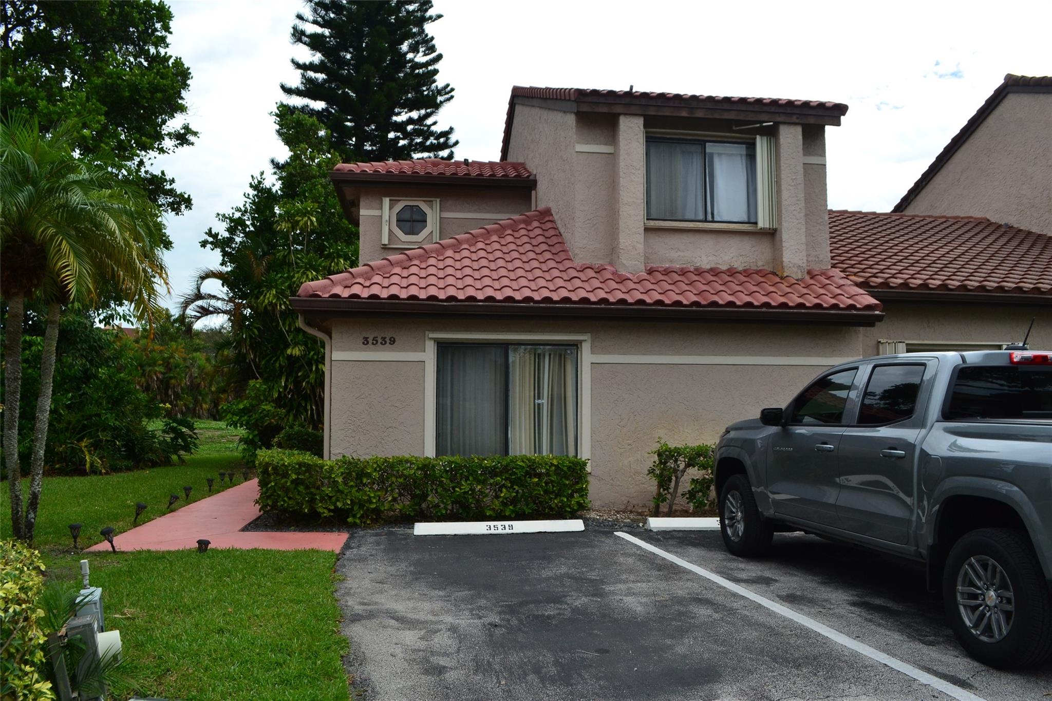 Great townhouse located in the quiet community of La Mirage featuring 3 bedrooms, 2.5 baths, newer AC (2024), master bedroom on first floor, re-roof in 2013, newer SS appliances, renovated master bathroom, accordion hurricane shutters, overlooking golf course, located in gated community, plenty of natural light in the living area, corner unit, two assigned parking spaces, and much more. This one will not last! Easy to show.