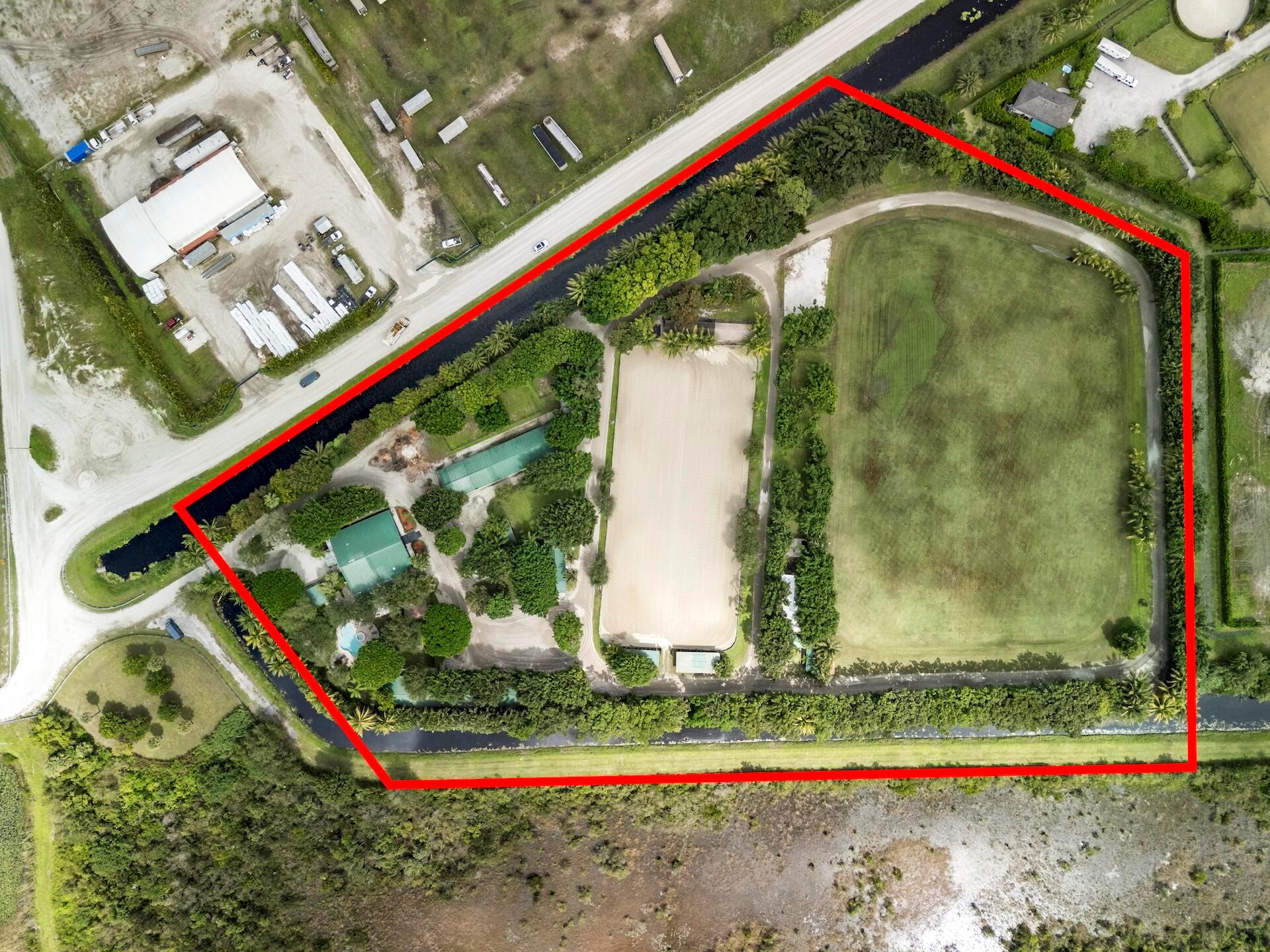 Happy Horse Farms is a rare 11 acre farm in the heart of Wellington. Opportunities like this are few and far between. Featuring a 50+ stall facility with multiple barns, run-in sheds, 8 paddocks, a 400' x 270' stick and ball field, a 275' x 124' clay arena, & four cabins. The recently renovated residence and players lounge provides functional accommodations for staff or management,  while the land and the layout present the perfect canvas for a custom luxury equestrian estate. With expansive acreage and extensive infrastructure already in place, the possibilities are endless. Design and build your dream farm exactly as you envision it. Whether for polo, hunter jumpers, or dressage, this property offers the space, location, and potential to become one of Wellington's premier Equestrian
