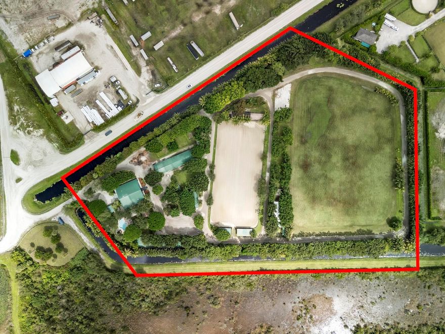 Happy Horse Farms is a rare 11 acre farm in the heart of Wellington. Opportunities like this are few and far between. Featuring a 50+ stall facility with multiple barns, run-in sheds, 8 paddocks, a 400' x 270' stick and ball field, a 275' x 124' clay arena, & four cabins. The recently renovated residence and players lounge provides functional accommodations for staff or management,  while the land and the layout present the perfect canvas for a custom luxury equestrian estate. With expansive acreage and extensive infrastructure already in place, the possibilities are endless. Design and build your dream farm exactly as you envision it. Whether for polo, hunter jumpers, or dressage, this property offers the space, location, and potential to become one of Wellington's premier Equestrian