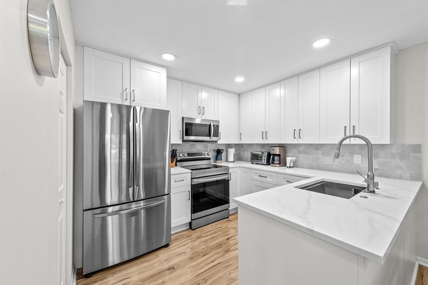 Turn-key 2BR/1.5BA corner condo in Pine Ridge IV (55+), fully renovated and offered at $192,250—including furniture, with a few exempt personal items. Furniture is negotiable or removable if the buyer is not interested. This beautifully updated unit features new flooring throughout, fresh paint, and a fully renovated kitchen with brand-new stainless-steel appliances, modern cabinetry, upgraded counters, and smart LED lighting. Both bathrooms include new vanities and mirrors, and the convenience of in-unit laundry makes this condo truly move-in ready. Enjoy peaceful lake views from the enclosed Florida Room with upgraded with storm-impact sliders for year-round use. The home also includes new accordion storm shutters for added protection.Located just steps from the clubhouse and pool. Whether you're seeking a seasonal retreat or a full-time residence, this condo checks all the boxes. With its turnkey condition, lakefront charm, and unbeatable location, it's a smart investment in a lifestyle of ease, comfort, and enjoyment If you like the furniture, it is Negotiable.