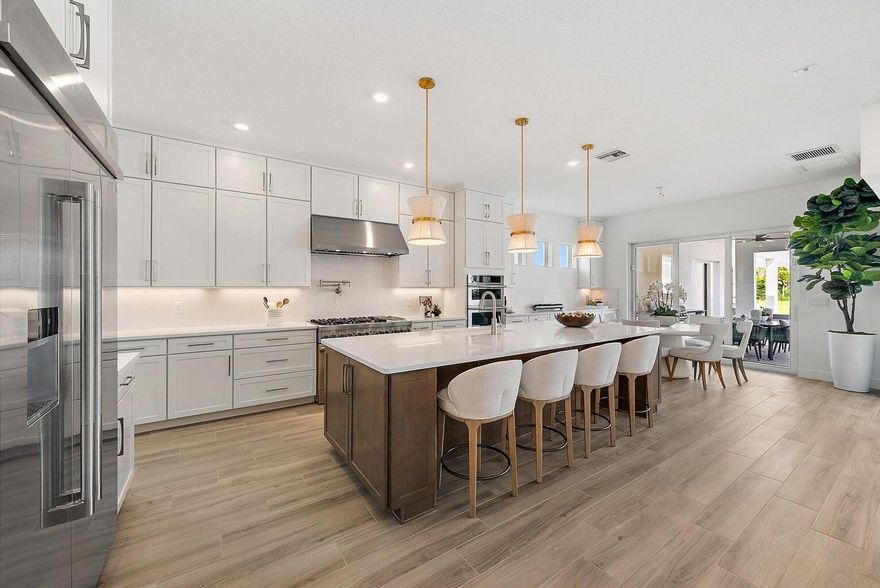 BRAND NEW, NEVER LIVED IN & PROFESSIONALLY DESIGNED is this gorgeous Livingston model POOL home nestled in the gated new Divosta community ''Bridgewater'' offering THE BEST LAKE & PRESERVE VIEWS! Sitting on a premium private 1-acre lot, this home offers 5 bedrooms PLUS a Den/Office, a Theater/Game Room & a large Loft! With 6.1 baths, a spacious 4 car garage & a separate Guest House which includes a spacious bedroom, walk in closet & full bathroom your guests may never want to leave. Step inside to find many features & upgrades which include; circular driveway, impact glass double front door entry, wood look tile floors on the main level, double doors @ 1st floor den/flex room, upgraded white shaker style wood kitchen cabinetry, Jenn Air SS appliances, DOUBLE dishwasher pot filler, large walk-in pantry, extended kitchen cabinetry with upper cabinetry for ample storage, quartz waterfall countertops with quartz backsplash, under cabinet lighting, all closets have custom built ins, upgraded sliding doors at breakfast area unto the lanai, volume ceilings in family room, wet bar, large laundry room with storage cabinetry & folding area, main level master bedroom with extended sitting area, double door walk out from master to the lanai, & a re-designed en-suite master bathroom; dual sinks, soaking tub, stand up shower, water closet & linen closet. Zero corner sliding doors welcome you into the fully fenced backyard featuring marble decking, great summer kitchen & a new pool & spa! Go up the wood spiral staircase onto the 2nd level to find hardwood floors throughout, 3 bedrooms with en-suite baths, a large loft and generously sized theater/game room with pre-wired audio to connect to your choice of surround system. New fixtures & fans throughout, not a detail has been missed in this functional floor plan! Come see this MASTERPIECE!