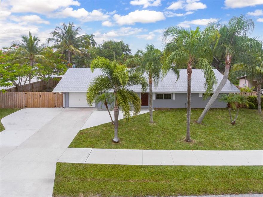 Tropical paradise located right in the heart of Jupiter. This turnkey home boast so many upgrades. Please see the complete upgrade list attached to MLS. 2022 interior/exterior paint, 2022 kitchen update, 2021 TRANE AC, 2020 stainless steel appliances, LG front load washer and dryer. 2018 roof. Spacious primary bedroom offers an updated bath complete with a beautifully tiled walk in shower. On the other side of the split floor plan you will find two large guest rooms, (1 w/ a walk-in closet) and 2022 updated spa like guest bath. Den/flex room that would make an ideal guest space with sliders to the pool. Outside you'll find a privacy fenced backyard oasis with large screened porch, custom stamped patio for lots of room for entertaining, Palm, Papaya, Banana & Guanabana.Plus RV /boat parking