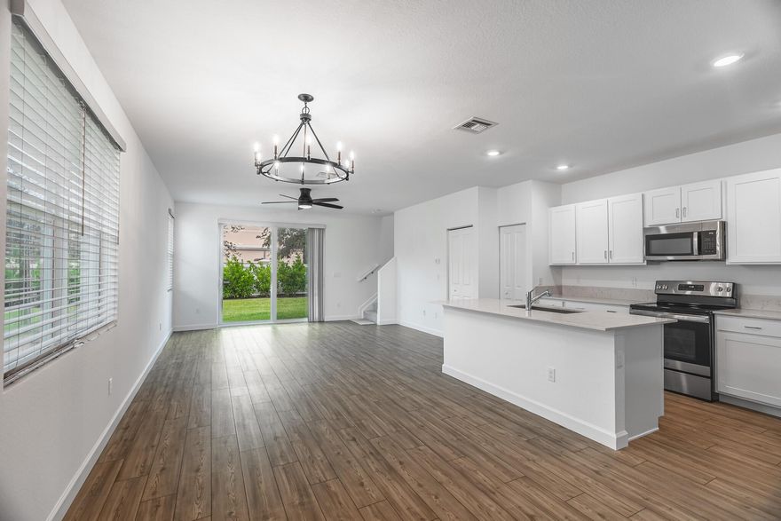 3 Bed with Den, 2 Bath, 1 Car Garage Townhome. Priced Below Market Value, Bring Offers! You Won't Want to Miss This Like New 2023. Prime Location Less Than 1 Mile from the Turnpike and Next to a Brand-New Hospital. Enjoy Impact Windows, Open Floor Plan, Quartz Countertops, Guest Half Bath, Low HOA in a Gated Pool Community! Main Suite Features Large Walk-In Closet, and Spa-Style Shower; Laundry is Upstairs. Virtual Tour Available. Just 15 Min To I-95, Central to Orlando & Miami, Across from Tesoro Country Club, and Close to Beaches, Golf, Boating & Parks.