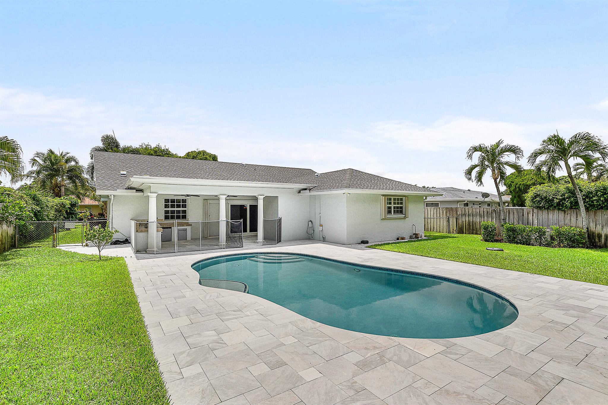 Welcome to this beautifully updated 3-bedroom, 2-bath home! Bright with wide-open floor plan. Outside is your private oasis - pool, upgraded pool deck, and a fully equipped summer kitchen--perfect for gatherings year-round. The windows are dressed with classic plantation shutters, and major upgrades include a 2024 roof, whole home generator, and a deep-water well irrigation system. For peace of mind, the home is fully hurricane-protected with impact windows, accordion shutters, and reinforced garage and entry doors. Centrally located in a highly sought-after neighborhood, you'll enjoy easy access to downtown West Palm Beach, beautiful beaches, parks, and Palm Beach International Airport and pickleball courts are just a short distance away.