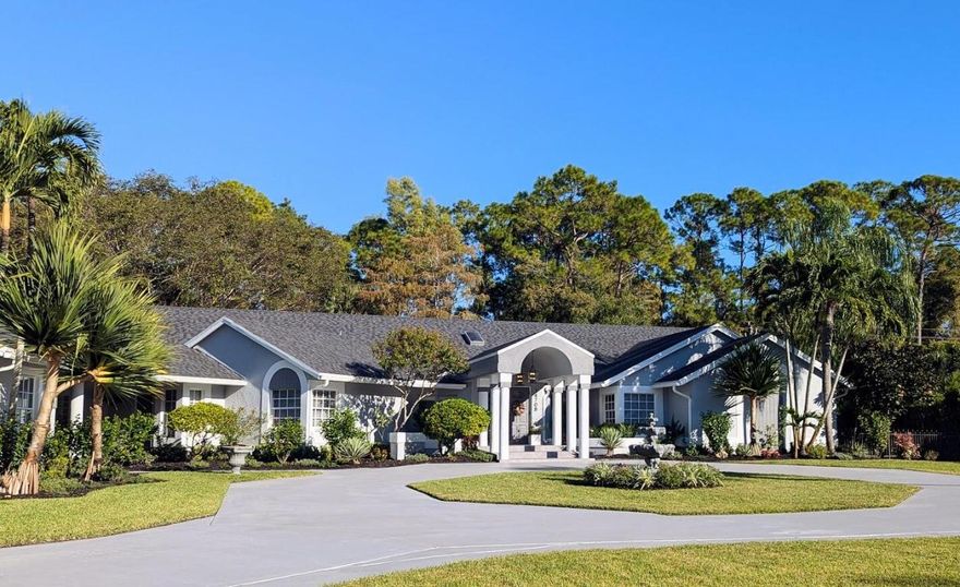 Enjoy privacy, peace and serenity in a park-like setting with this 3.33 acre Paddock Park gem which is one of the largest lots in this highly desirable community, with no HOA. The one story main house features 5 bedrooms and 3.5 baths along with an attached, oversized 4 car garage with AC, separate access and private parking from the main house, along with a detached 1/1 guest house. There is plenty of room to add a tennis, basketball or pickleball court to the backyard or a variety of other projects enabled by the sprawling lot. In terms of land and location, it does not get much better than this. A+ Wellington schools, 20 minutes to PBIA and access to everything Palm Beach has to offer. Your personal finishing touches will make this the compound you have dreamed about! The front porch stairs lead to a double-door entrance with interior stairs that flow into several open concept spaces. There is an oversized circular driveway that will accommodate many vehicles along with a separate (long and wide separate driveway) that accesses the garages for boat, trailer or toy storage. The large, screened rear porch runs the entire length of the open floor plan which overlooks the 2 acre fenced back yard, with mature trees and sliding glass doors opening to the patio. The home offers a split plan with large rooms and lots of open space.The master suite and new master bathroom are across the hall from the coziest bedroom, nursery or office with an ample closet and pocket door access to the half bathroom. The laundry room is a buffer in-between the two areas and has an exterior door and covered walkway to the garage, or if there is a guest that would rather not traverse the entry stairs, this is the ideal entry point as it is also parallel to the driveway. The other side of the house features two bedrooms connected by a jack and jill bathroom with a spa tub/shower combination and dual vanities.The final bedroom has its own private bathroom with a cabana door to the patio/pool and a walk-in shower. The main house has a new roof (2024), new screening (2024), painted inside and out (2025) all remodeled bathrooms, new tile throughout, baseboards, doors and hardware in the main house (2025). There is also a whole house Aquasoft R/O system with an 800 gallon water tank, 22W Generac propane generator that operates an efficient portion of the main house if there is electricity interruption. Two different kitchens were created for the space but ultimately, it could be a very large kitchen or a smaller, but functional kitchen. At the end, it was decided that the kitchen space would be left as a blank canvas for the new owner to do what was in their best interests and for their needs and taste. The 2+ acre backyard is fully fenced with a separate dog run, and separate access from the main house. The front of the property could easily be fenced/gated if you require more privacy. The front of the house does not face another home directly and the property is lushly landscaped with tall hedges or large palms for additional privacy on both sides. The 988 sq ft. guest house has been used as a rental during season, a home theater, as accommodations for live-in help, and as a guest space. The bedroom is on the second floor and the guest house is partially furnished. The patio and walkways in the backyard feature pavers with a walkway from the main house to the guest house which has a covered, open front porch and a pergola for shade on the back porch. The entire property is lushly landscaped with $50k of new sod, plants and trees to accompany the many beautiful mature and exotic trees that have been growing on the property for years. The property also has a 16 zone rainbird sprinkler system.There is approx ½+ acre that is still uncleared land in the rear of the property that further insulates the feeling of a private park while also providing a buffer to any noise.  The front of the property can be easily be fenced/gated if you require more privacy. The front of the house does not face another home directly and the property is lushly landscaped with tall hedges or large palms for additional privacy on both sides. The 988 sq ft. guest house has been used as a rental during season, a home theater, as accommodations for live-in help, and as a guest space. The bedroom is on the second floor and the guest house is furnished. The patio and walkways in the backyard feature pavers with a walkway from the main house to the guest house, which has a covered, open front porch and a pergola for shade on the back porch. The entire property is lushly landscaped with $50k of new sod, plants and trees to accompany the many beautiful mature and exotic trees that have been growing on the property for years. The property also has a 16 zone rainbird sprinkler system.There is approx ½+ acre that is still uncleared land in the rear of the property that further insulates the feeling of a private park while also providing a buffer to any noise. Ideal location, A rated schools with privacy and room to roam.