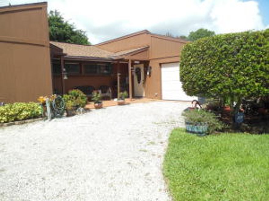 Pride of ownership shows in this country style home in Indian River Estates on 3/4 acre private lot. Potential to split 3rd lot for future sale. Relaxing front and back porches, extra large workshop with electric is perfect or someone with a business or lots of Toys. Also includes 2 car carport. Upgrades include emergency generator hookup wiring, accordion shutters, alarm system, newer appliances, French doors, hooked up to city water, nicely landscaped, all window treatments custom stay.