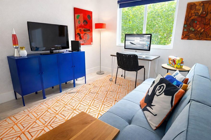 Welcome to The Grove! A highly sought-after gated community just a short stroll from the vibrant Wilton Drive! This beautifully updated unit offers an open-concept kitchen and living space complete with granite counters, stainless steel appliances, double ovens, a water filtration system, and a breakfast bar perfect for entertaining. The newly renovated modern spa-style bathroom features a step-in shower with sleek glass doors. Both spacious bedrooms include blackout shades and custom-designed closets. Impact windows and doors throughout for peace of mind. Enjoy the resort-style community pool and clubhouse, an immaculate on-site laundry room & convenient parking directly out front. All of this just minutes from premier shopping, dining, and endless entertainment options.