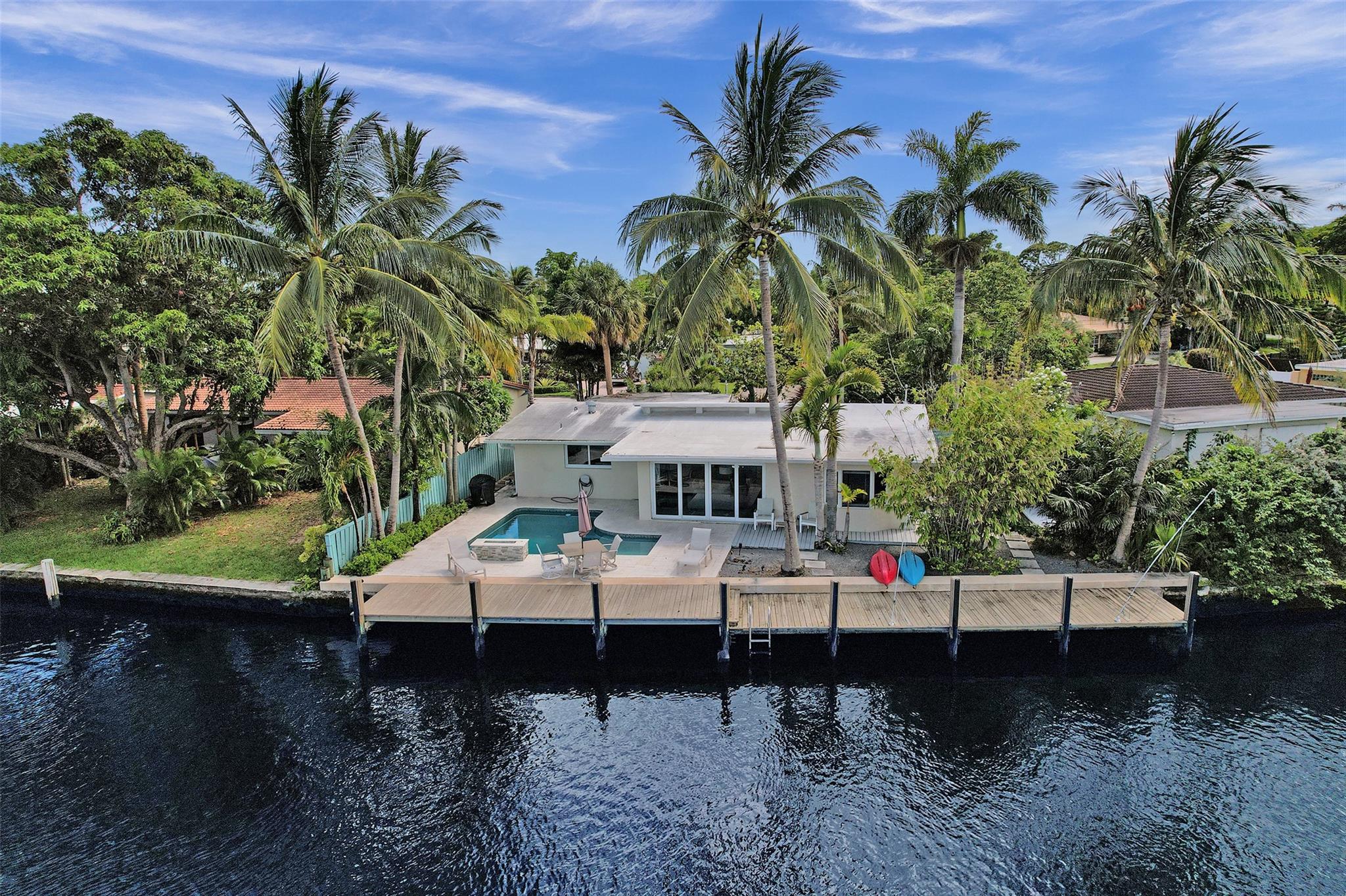 STUNNING EAST WILTON MANORS 3/2 WATERFRONT HOME IN SOUGHT-AFTER CORAL GARDENS NEIGHBORHOOD. NO EXPENSE WAS SPARED IN THIS COMPLETELY RENOVATED HOME. LOFT-LIKE, VAULTED CEILINGS, AND A SEAMLESS FLOW FROM ENTRY TO BACKYARD ON THE NORTH FORK OF MIDDLE RIVER. INTERIOR FEATURES A COMPREHENSIVE RENOVATION WITH QUARTZ COUNTERTOPS IN KITCHEN AND BATHS, IMPORTED GLASS TILE BACKSPLASH, BLANCO SOLID SURFACE SINK, NEW APPLIANCES INCLUDING PROPANE RANGE, AND NEW ELECTRICAL SYSTEM. IMPACT GLASS SLIDERS. NEW 2020 ROOF, PROPANE GAS TANKLESS WATER HEATER. EXTERIOR BOASTS A COMPLETE POOL RENOVATION WITH FIRE PIT AND WATERFALL, 80' WATERFRONT, RAISED SEAWALL, NEW PILINGS, AND 70' DOCK. PLUS, MUCH MORE. BEING SOLD FURNISHED.
