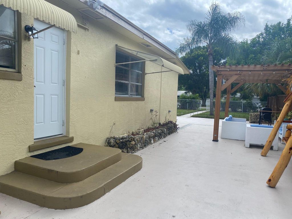 Photo of 135 Hawthorne Drive, Lake Park, FL 33403 (MLS # R11114878)