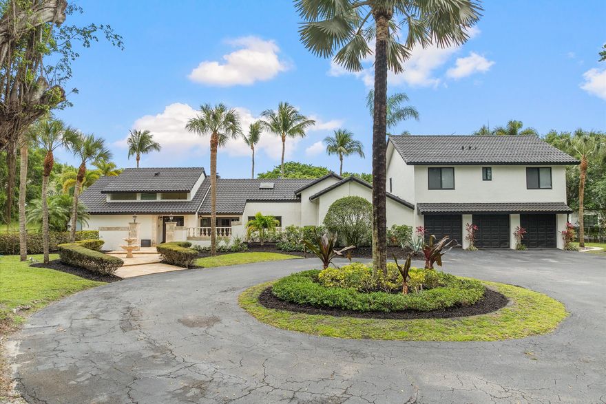 Welcome to an exceptional custom estate nestled within the prestigious 24/7 guard-gated community of Tierra Del Rey—offering a rare opportunity to own 2.5 acres of prime waterfront property in one of South Florida's most sought-after locations. This one-of-a-kind luxury residence features 7 spacious bedrooms, 4.5 bathrooms, and is thoughtfully designed for both elegant living and everyday comfort.  The main level offers 4 bedrooms and 3.5 full baths, while the second floor showcases a private retreat complete with an expansive loft, kitchenette, 3 additional bedrooms, a full bath, and a dedicated laundry area—ideal for multigenerational living or guest accommodations. A striking double-sided wood-burning fireplace adds warmth and character to the living spaces.  Welcome to an exceptional custom estate nestled within the prestigious 24/7 guard-gated community of Tierra Del Rey—offering a rare opportunity to own 2.5 acres of prime waterfront property in one of South Florida's most sought-after locations. This one-of-a-kind luxury residence features 7 spacious bedrooms, 4.5 bathrooms, and is thoughtfully designed for both elegant living and everyday comfort.  The main level offers 4 bedrooms and 3.5 full baths, while the second floor showcases a private retreat complete with an expansive loft, kitchenette, 3 additional bedrooms, a full bath, and a dedicated laundry area—ideal for multigenerational living or guest accommodations. A striking double-sided wood-burning fireplace adds warmth and character to the living spaces.  The gourmet kitchen is equipped with solid wood custom cabinetry and stainless steel appliances, seamlessly blending style and functionality. Throughout the home, enjoy custom closets, impact windows, screen porch and three brand-new A/C units (2024) with lifetime warranty, along with a new water heater (2024) for peace of mind. Step outside to your own private resort pool and spa recently resurfaced, surrounded by lush tropical landscaping and expansive waterfront views. Entertain with ease featuring a fully equipped outdoor summer kitchen, private lighted tennis court, and plenty of space to relax and unwind.  Additional highlights include a 3-car garage plus golf cart access, a pet-friendly community, and the unique charm of local wildlife, including peacocks that enhance the serene, natural setting.  Perfectly located just minutes from Delray Beach and Boca Raton's premier shopping and dining, with convenient access to the Florida Turnpike and situated within top-rated Boca Raton school zones.  Available immediately—this is luxury estate living at its finest.