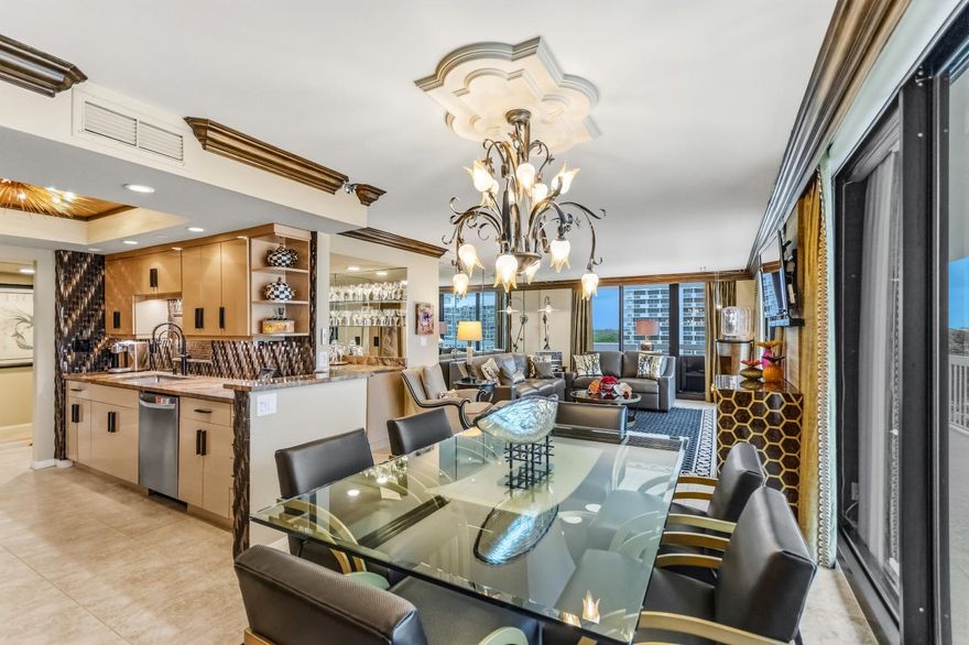 Gorgeous, fully renovated 7th-floor waterfront condo featuring 2 bedrooms and 2 bathrooms with stunning views of the Intracoastal Waterway and Marina. The beautifully updated kitchen, renovated just one year ago, showcases custom cabinetry, stainless steel appliances, an induction cooktop, and elegant quartzite countertops.  A matching bar with a wine refrigerator makes the space perfect for entertaining. IMPACT windows and doors, electric shades are installed throughout the condo. Spacious primary suite features a large walk-in shower, soaking tub, dual vanity, makeup vanity, and two walk-in closets. The guest bedroom includes a custom library-style Murphy bed with a queen mattress. The living and dining areas overlook the marina, and all main living spaces enjoy beautiful water views.  The renovated guest bathroom features a walk-in shower. Laundry room inside unit. Community amenities include a heated waterfront pool, hot tub, saunas, BBQ area, community room, and additional storage. One assigned covered carport parking space is included. Ideally located close to shopping, dining, golf courses, and miles of beautiful beaches. Old Port Cove is a secure, gated waterfront community offering a Marina, Belle's Restaurant, and a scenic waterfront walking path.