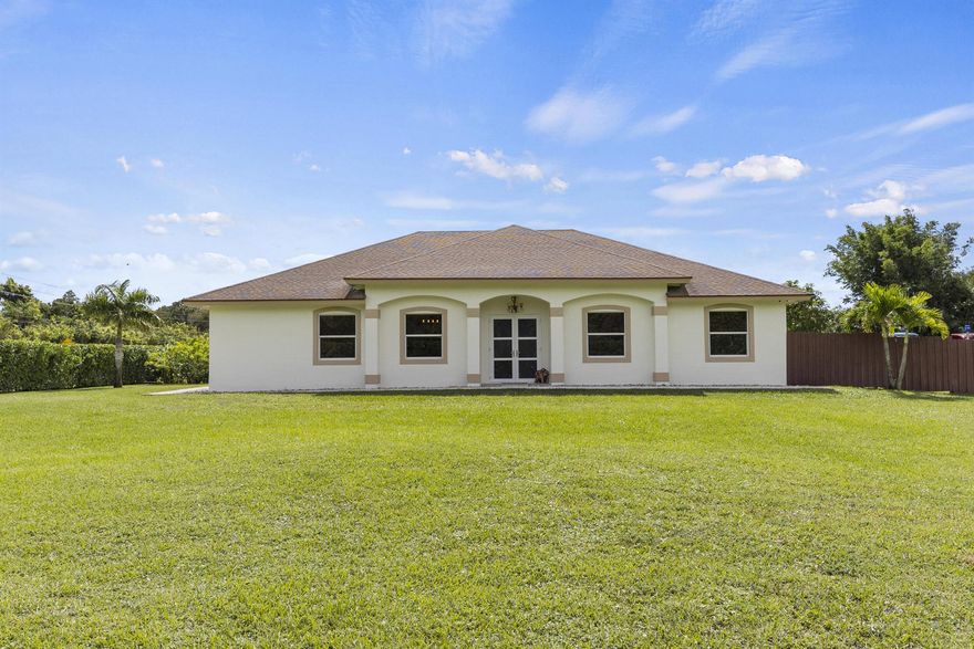 Have you been dreaming of a spacious, modern 3-bedroom, 2-bathroom home where you can finally escape the constraints of an HOA and embrace true Florida acreage living? Your search ends here--this beautifully updated Loxahatchee property delivers the perfect blend of equestrian-friendly serenity, security, and unrestricted freedom.This is the ultimate NO HOA paradise on a high and dry 1.42-acre corner lot, significantly fortified and elevated with approximately 175 loads of fill for unparalleled peace of mind. The community offers a safe, peaceful setting ideal for bike riding, trail riding, and quiet evening walks. The property is beautifully fenced for safety and privacy and is zoned in a well-regarded Palm Beach County school district (buyer to verify). Outdoor living is exceptional: