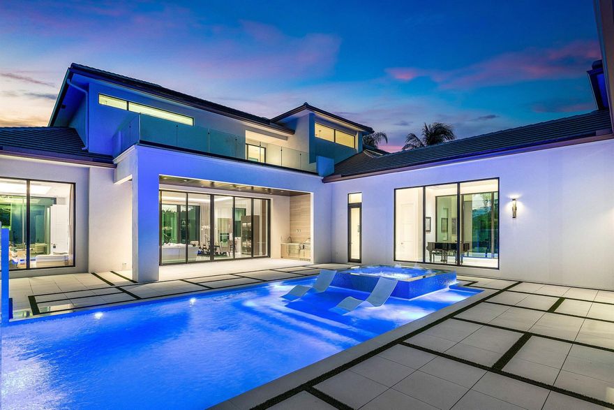 An architectural gem newly constructed in 2024, this custom-built courtyard home showcases expanses of glass that seamlessly integrate the indoor and outdoor environments. 12' glass windows and doors which frame eastern and western views illuminate the home with natural light. Modern design elements, coupled with hardscape accents in geometric form, create a stunning effect.The interiors have a refined, sophisticated aesthetic with soft tones and exquisite finishes. The home offers 5714 living sq ft, 4 ensuite bedrooms, 5.5 baths, office, entertainment room (which can be converted to a  5th bedroom with a full bath), temperature-controlled 200 bottle wine room, glass-railed floating staircase, music gallery, and 3 air-conditioned garage spaces (constructed to accommodate 6 cars using