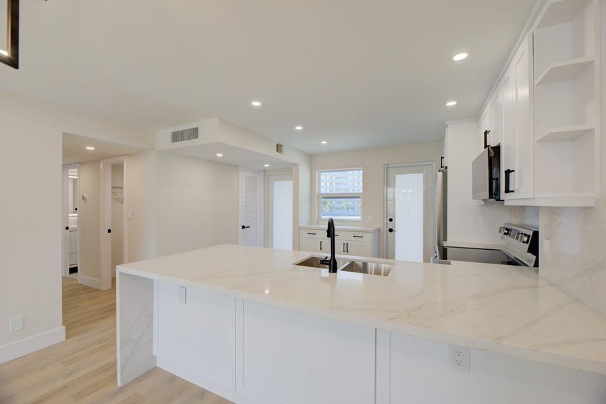 Look no further for coastal Elegance-Tastefully renovated 2 bed 2 bath unit with NEW hurricane Impact Windows and Doors. Big balcony with a pool view. Spectacular open concept kitchen with quartz countertop and LG S.S appliances including a range fan built-in microwave. Guest bath has a tub-shower combination-shower only in the main bathroom. Luxury Vinyl Plank waterproof flooring through out the unit. New electrical box, 2023 AC unit and newer water heater. 1 assigned parking spot & guest parking available. Granada House offers a BBQ area, community room, heated pool, laundry facilities on every floor. THIS FINE HOME IS WAITING FOR YOU STEPS AWAY OF EVERYTHING FUN & EXCITED. Just a short drive to WPB, Miami and Fort Lauderdale International Airports. MAKE IT YOUR BEACH RETREAT TODAY!