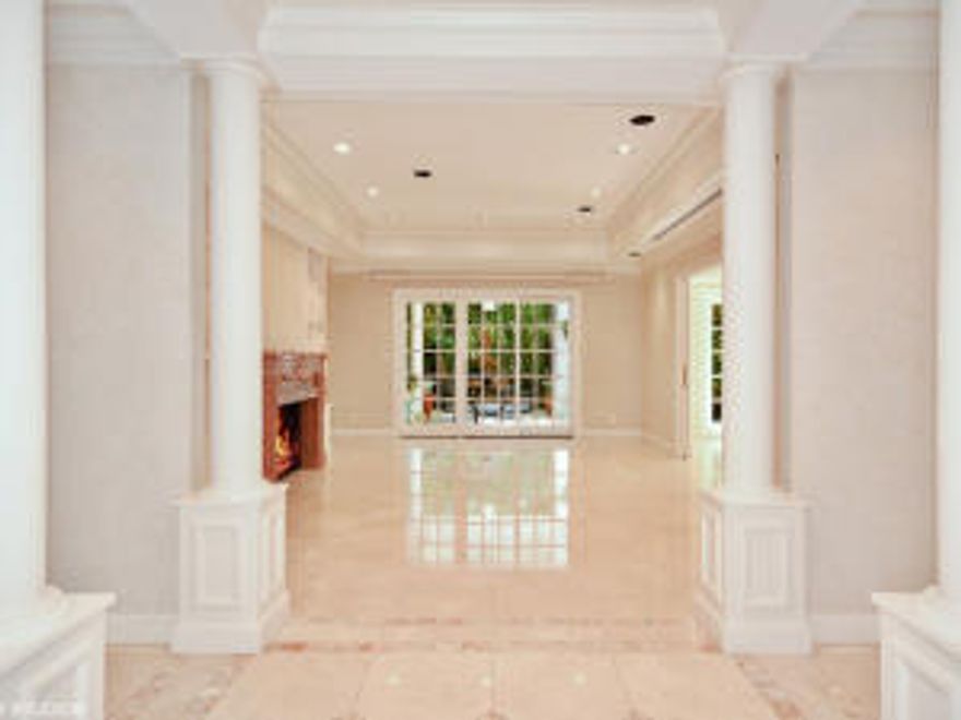 Wonderful private retreat on quiet northend street. Stylish and bright 3-beds, 3.5-baths. Master suite with library. Marble baths. 2-car garage.  Elevation Certificate - 8.2 ft.Great bones & millwork details provide a wonderful opportunity to create a casual-ambiance, Hive-style home with easy access to the Lake Trail and best beach on The Island. The elevation is 8.2ft.The Siematic Chef's Kitchen allows layout options for open-plan living & al fresco dining. The oversized 100'x115' tropically landscaped l