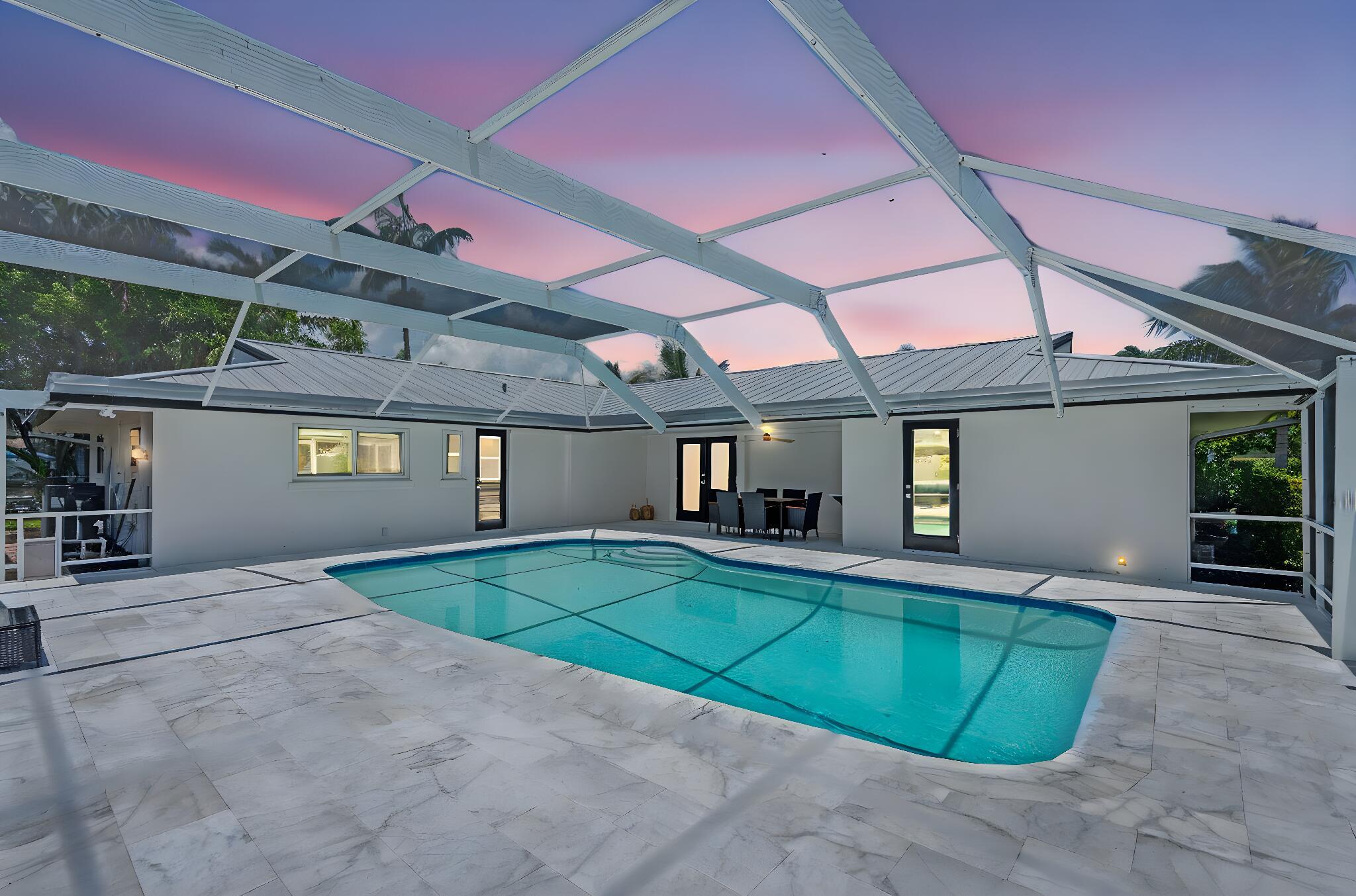 Welcome to 1081 Bimini Lane -- the perfect combination of elegance, entertainment, and joyful relaxation. This beautifully renovated 3-bedroom, 2-bath open-concept home is nestled on the coveted Singer Island, just steps from the beach, scenic finger canals leading to the Intracoastal, and an array of shops and restaurants. Step into a bright, spacious living area filled with natural light and brand-new flooring throughout. The luxuriously remodeled kitchen features sleek European-style cabinets, quartz countertops, stainless steel appliances, an expansive peninsula, and a touchless faucet -- all seamlessly connected to the dining area and a stunning elegant wine wall. Two lazy Susans add thoughtful functionality. An entertainer's dream! The master bedroom is spacious and airy, with...