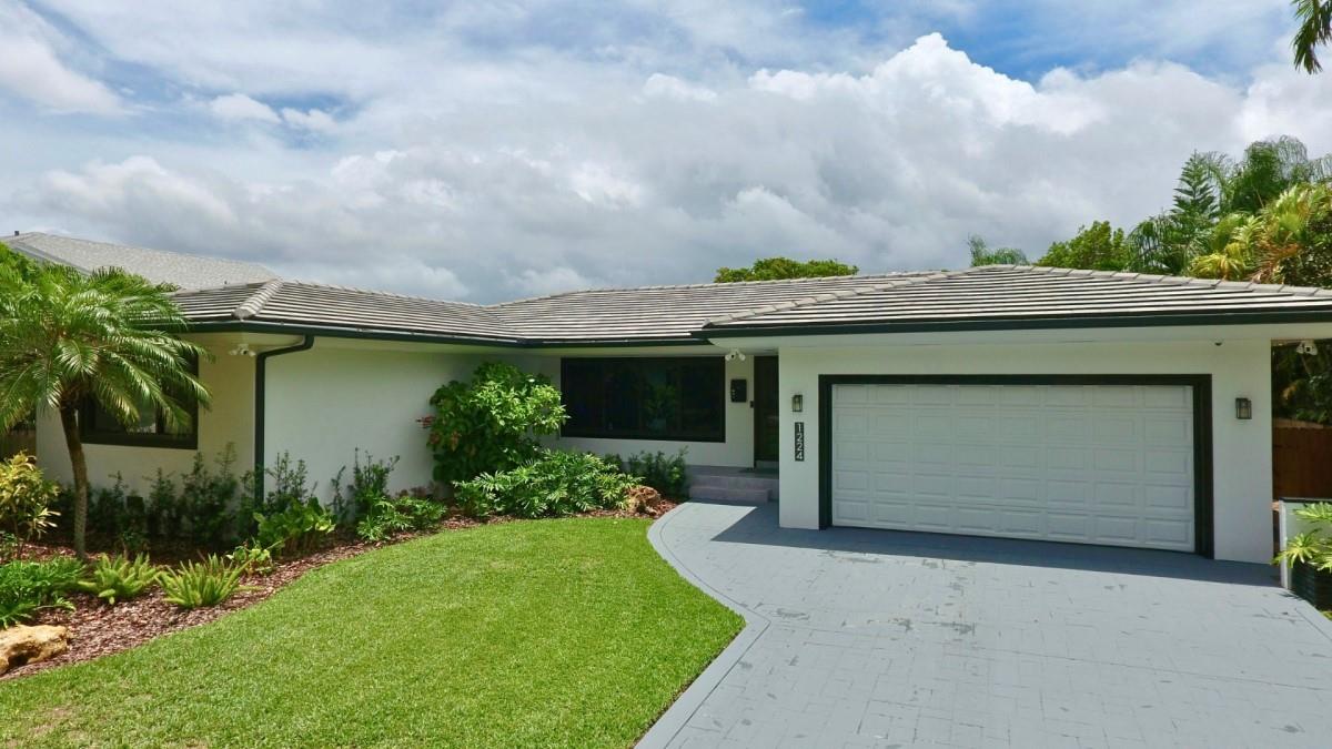 Welcome to 1224 North East 96th Street, situated on an oversized lot (0.26) acres, in the heart of Eastern Miami Shores. This move-in ready oasis on Miami Shores' most coveted streets offers 3 bedroom, 3.5 newly renovated bathrooms, two-car garage with spacious storage room, open functional floor plan with covered outdoor resort style pool area. New Italian porcelain floors throughout, new open kitchen with bar top island, custom countertops, farmers sink, and new smart appliances including a wine cooler. Outdoor resort style pool area with pergola surrounded by lush tree-lines and astro turf. Brand new Generac generator, new air conditioning unit, new electrical wiring, new roof. Come experience the epitome of Miami living in this stunning, move-in ready home on NE 96th Street.