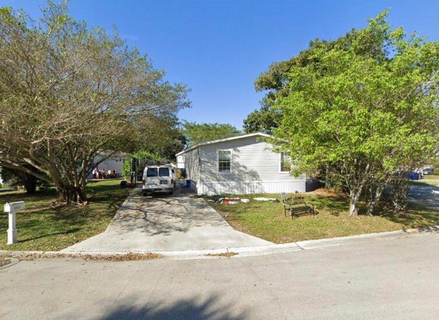 Welcome to this beautiful 2020-built manufactured home located in a highly desirable Boca Raton neighborhood with a great school district. This 4-bedroom, 2-bathroom home features a spacious open-concept layout, seamlessly connecting the kitchen, dining, and living areas - perfect for entertaining and everyday living. The modern kitchen includes a large island, ample cabinetry, and flows directly into a bright, inviting living space. The home offers approximately 1,512 sq ft of living space and sits on a 0.15 acre lot, providing both comfort and outdoor flexibility. Step outside to enjoy a large backyard and a long, oversized driveway, ideal for multiple vehicles, guests, or even a boat. The exterior is well-maintained, and the property offers privacy and functionality. This won't last!