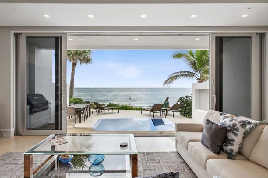 This extraordinary townhome beautifully situated on the sand in the highly sought after town of Highland Beach is just what you have been searching for.  Stunning ocean views from every level do not disappoint, you won't be able to look away!  Open and easy living from the Chef's kitchen, dining and living room open up to the deck and private pool with stairs down to the beach.  3 car garage, elevator, media room and flexible open space with luxurious master suite and balcony draw you out.  Guest bedroom suites to meet every need with bonus space on upper level and a roofdeck with panoramic views of the ocean from sunrise to sunset.  OPV will leave a fortunate few wanting for nothing and lucky to call it their own, make it yours today.  This one won't last!