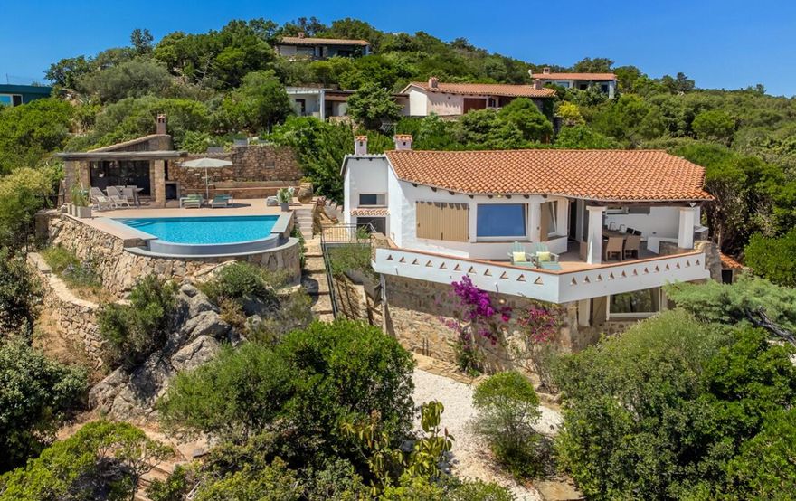 Villa Tavolara is an elegant Mediterranean-style residence set on the hillside of Cala Girgolu, offering breathtaking panoramic views of the bay and iconic Tavolara Island. Surrounded by lush Mediterranean vegetation, this exclusive property blends privacy, comfort, and natural beauty.The home features four bedrooms, four bathrooms, a double living room, a dedicated living and working area, two fully equipped kitchens, and expansive terraces designed for seamless indoor-outdoor living. The outdoor spaces include a stunning infinity pool overlooking the sea, sun loungers, a rustic outdoor kitchen, and multiple al fresco dining areas.An exceptional opportunity to own a private retreat or investment in one of Sardinia's most desirable coastal locations. PRICE IS IN EUROS