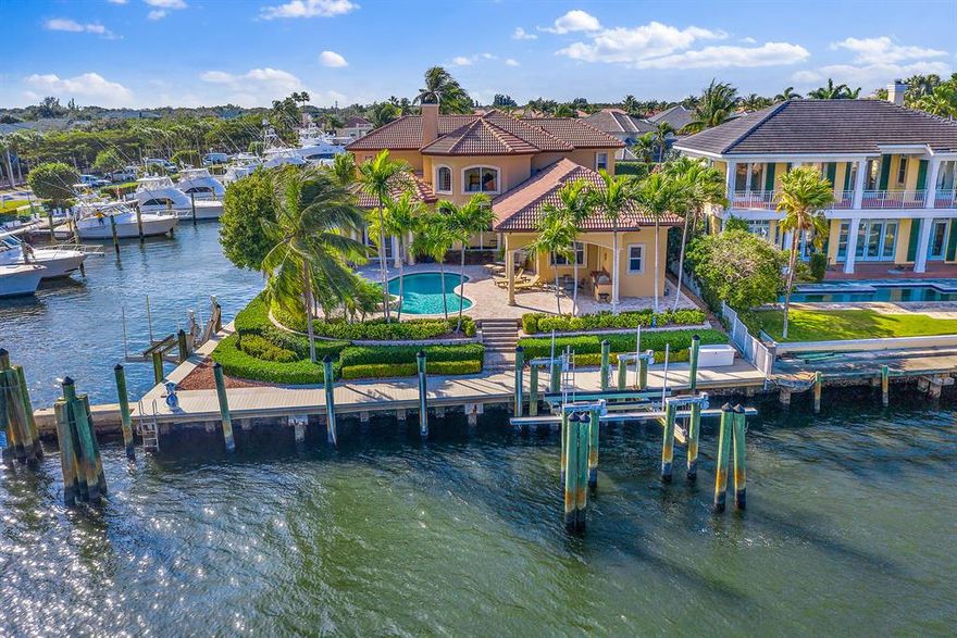 Rare Southeast facing Intracoastal point lot in a gated enclave with long panoramic views, 240' of frontage, No-Wake zone, 30,000lb & 14,000lb lifts and a 3 car a/c'd garage. Other features include a first floor master suite, marble and wood flooring, impact glass doors and windows, 22KW Generac generator and Gourmet kitchen with European Maplewood cabinetry, stainless appliances and a natural gas cooktop.