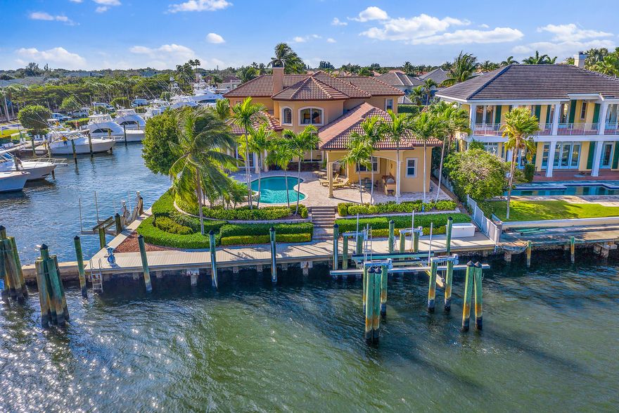Rare Southeast facing Intracoastal point lot in a gated enclave with long panoramic views, 240' of frontage, No-Wake zone, 30,000lb & 14,000lb lifts and a 3 car a/c'd garage. Other features include a first floor master suite, marble and wood flooring, impact glass doors and windows, 22KW Generac generator and Gourmet kitchen with European Maplewood cabinetry, stainless appliances and a natural gas cooktop.