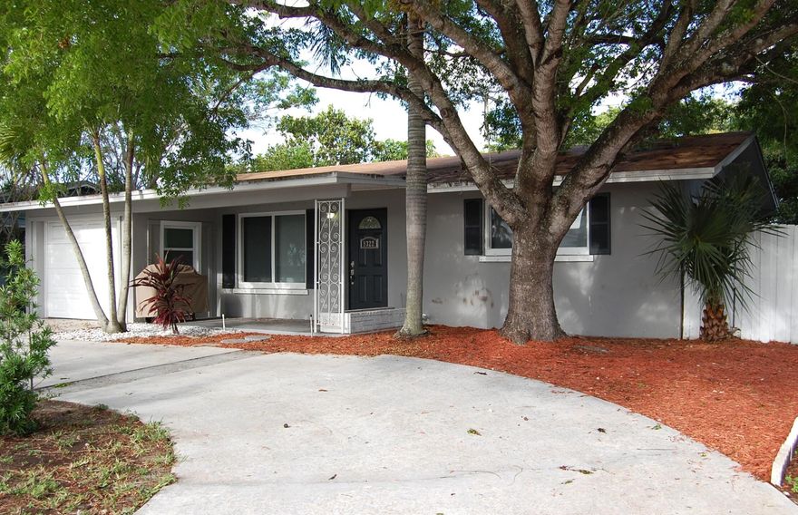 Great ranch-style home in the heart of Palm Beach Gardens! This 2-bedroom, 1.5-bath CBS residence sits on an oversized, fully fenced yard.  The home features an open living and dining area that flows into a spacious Florida room and sliding doors leading to the patio and backyard. Recent upgrades include ceramic wood-look plank flooring throughout the living areas and bedrooms, a 2023 A/C system, , a 2021 roof, and a freshly painted interior. Additional features included recessed lighting, and ceiling fans throughout Newer range and Microwave. A large circular driveway, and 1 car garage. Located in a desirable, non-HOA neighborhood close to shopping, dining, and parks. This home offers comfort, convenience and incredible value. Seller has just installed 5 new impact windows.