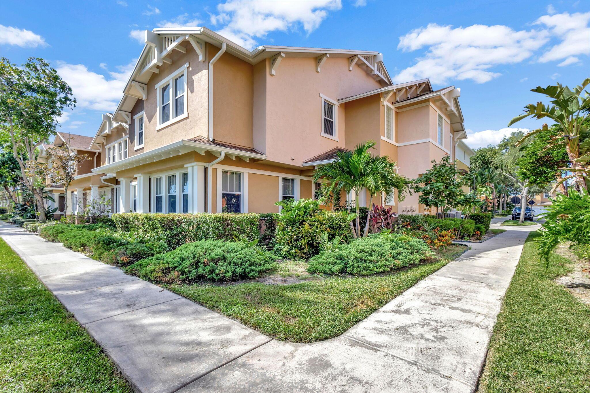 2 bedroom corner unit near the heart of it all, with attached oversize 2 car garage! New AC unit installed in 2022. This townhome with soaring ceilings is awash in plenty of natural light throughout the day. Kitchen features granite counters, pull-down faucet & stainless appliances. Primary bath with walk-in closet and dual vanity sinks. Full size washer/dryer in designated laundry room. 5 minutes from downtown West Palm, I-95, and PBI airport. Walk across the street to the new Palm Beach Outlet Shops, Whole Foods, Target, and multiple restaurants. Community amenities include 24hr manned gate w/ nightly roving patrol, HUGE lakeside pool, recently renovated gym and lakeside jogging track. Water, trash removal, master insurance, cable & internet service included w/ HOA