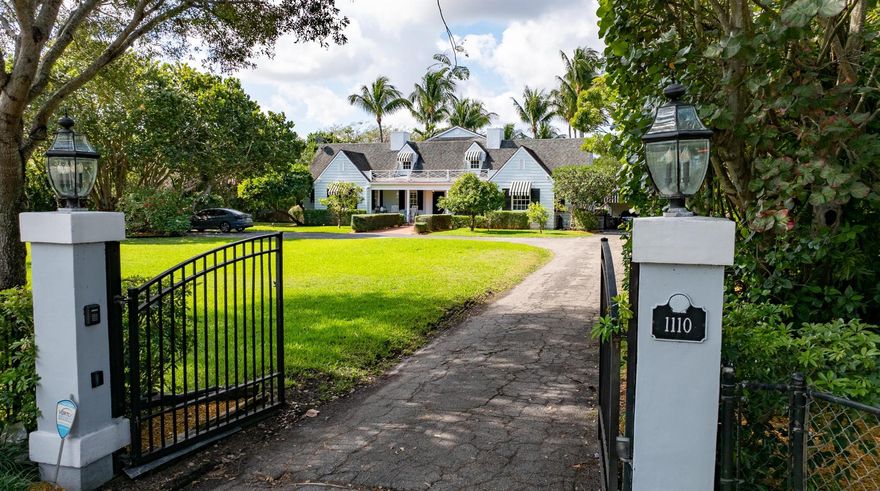 An exceptional offering, this 1936-era historic colonial-farmhouse-style estate presides over 1.3 acres of lushly landscaped grounds graced by majestic banyan trees, sprawling lawns and billowy palms. Seamlessly combining the classic traditions of its vintage heritage with gracious modern appointments, this extraordinary residence is astutely reimagined for today's refined style of living.