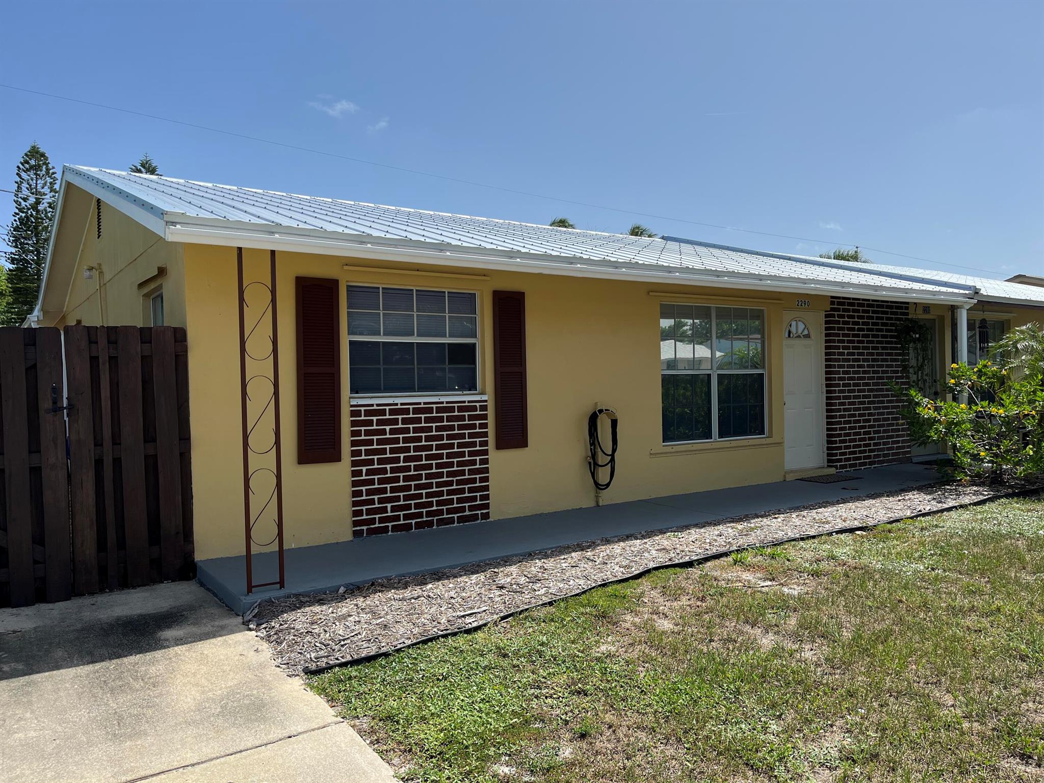 Jensen Beach Cozy Retreat! Upgraded Beautifully 2 bed/1 bath Duplex located just a short walk to the River and minutes to Downtown Quaint Jensen Beach. Pristine interior with new Cabinets, Granite tops, Tile Backsplash, SS Sink, Range/Hood and Refrigerator. Freshly painted, Tiled Floors with new vinyl flooring in both bedrooms. New lighting/Fans and Blinds on ALL windows.....Ready for your Move-In! Metal Roof(2024), Gutters, HVAC(2023), HWH(2024) and complete H Panels. Laundry room already has your Newer Washer and Dryer in place. HUGE Screened Porch and fenced backyard. Bring your favorite Pet! County Taxes and Utilities. Best priced, Renovated home in Jensen Beach!