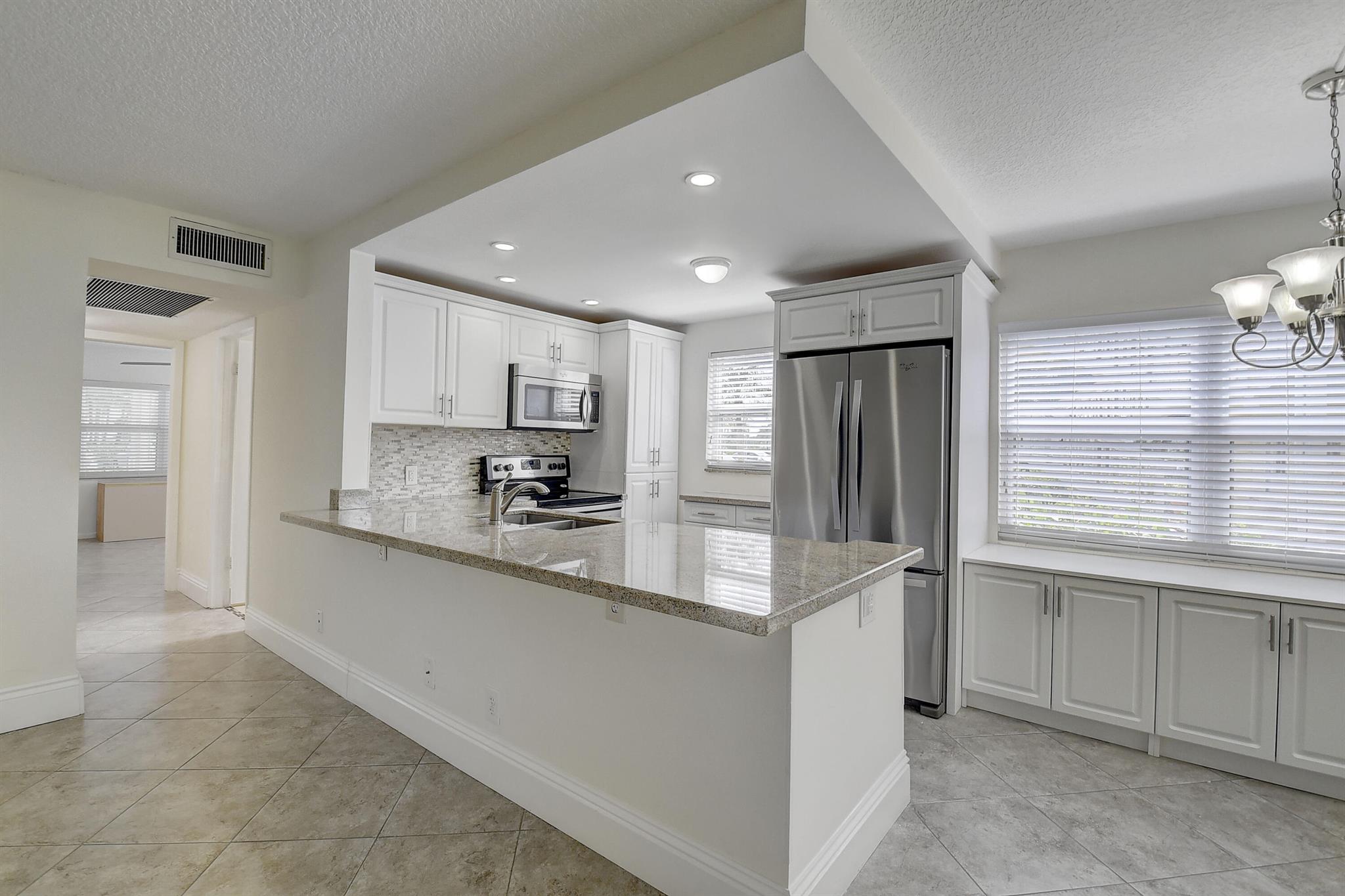 Welcome home to paradise. Turnkey 2 Bed 1.5 Bath. Hurricane windows throughout. Century Village is a 55 community that features many amenities, multiple swinging pools, pickle ball courts, first class shows, bus service, bike paths, and much much more