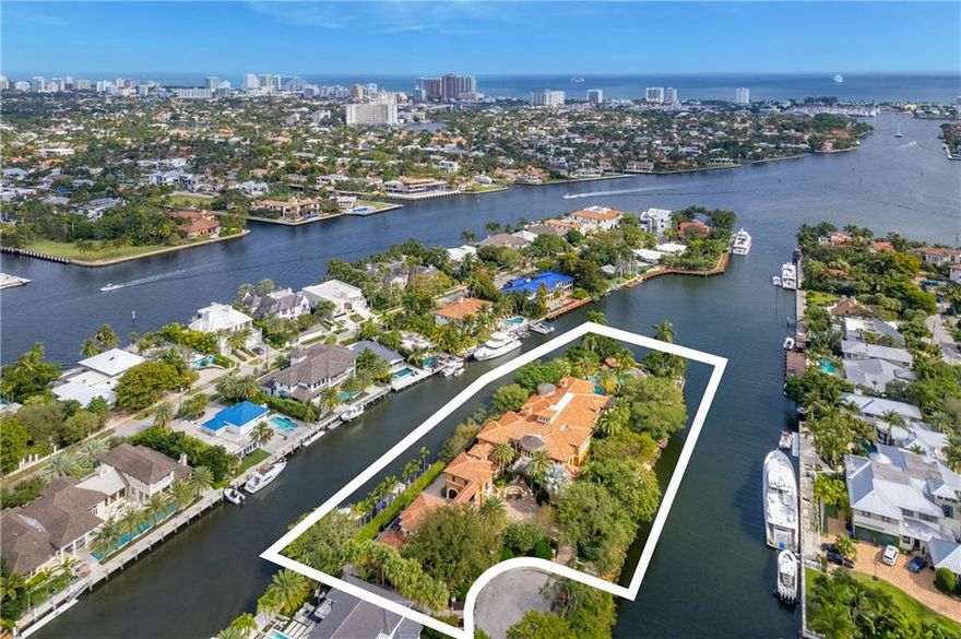 Mizner inspired Mediterranean point lot estate in the historic neighborhood of Rio Vista! Custom built property,  privately tucked away on over an acre of land w/ lush landscaping,a true tropical paradise. Designed by Randall Stofft Architects, home features mahogany framed windows, theater, office, elevator, aquarium, guest house, exotic stone & intricate architectural millwork throughout, a 1-of-a-kind masterpiece. State of the art commercial grade lighting, security & music systems. Relax in the generous master suite w/ his & hers bathrooms, closets, sitting area & wraparound terrace overlooking the water. Sit outside by a resort-style pool & waterslide, swim up bar & tanning shelf. Easy ocean access w/ +/- 700' of WF perfect for the avid boater. Close to shops, dining, Airport & beach.