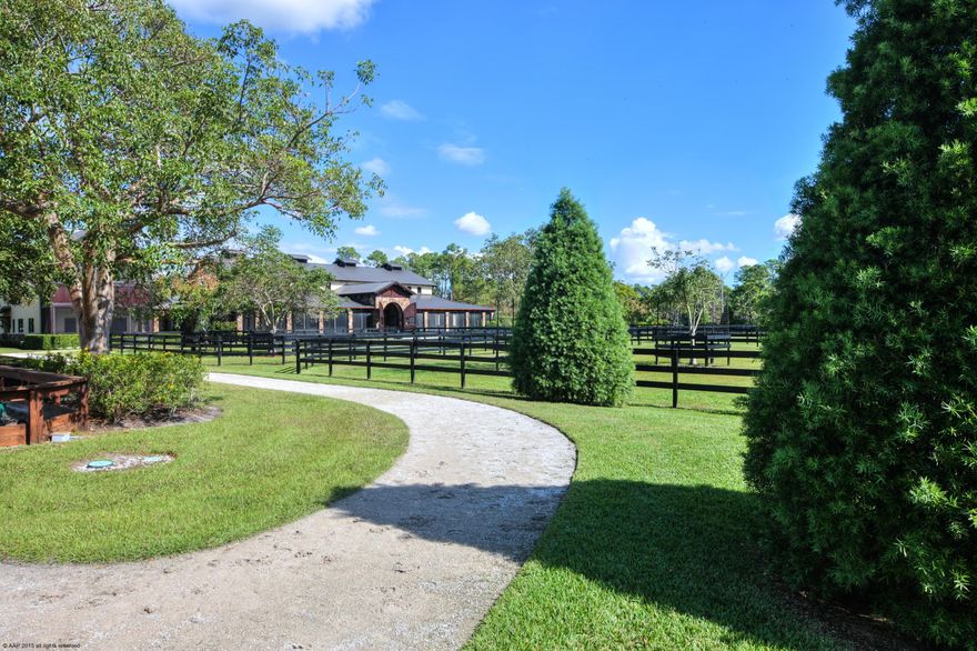 Private 15 acre custom designed home with top equestrian facilities. Unmatched in quality, design & finishes, probably one of the areas finest built properties.  Every detail was meticulously considered.  Stunning stable with exposed wood beam trusses, 3 grooming bays, wash & storage areas. Riding arena with underground watering system, hot walker and round pen.  Beautifully landscaped with private hacking paths throughout which complement the subdivision's trail system. Three grooms apartments and separate ancillary buildings with veterinary / farrier rooms, feed storage and multiple equipment bays.  The main residence features cathedral ceilings, fireplace with floor to ceiling stone chimney, wood & marble floors, elevator, a screened balcony and infinity pool with private water vistas. Sculpture at fountain in barn does not convery.

Property information:

Lawn maintenance: $3,500 (includes mowing, tree trimming, flowers, fertilizer & sprinkler system maintenance).

HOA Dues: $1050 Per lot = $3,150 Quarterly

FPL (electric) Annual Average: $975/mo. House & Barn & Apts $750/mo.

Generator maintenance: $105/Mo.

Pool & Koi Pond: $295/Mo.

Square footage:
Main House: 6,226 Air conditioned living space
Attached Garage: 1,090 Sq. Ft.
Screened Porch: 215 Sq. Ft.
Patio 3,156 Sq. Ft.

Stable: 10,200 Sq. Ft. Total. (5,546 excluding walkway.)
Feed & Farrier Building: 48' x 14'  = 672 Sq. Ft.
Storage & Manure Building: 96' x 24' = 2,304
Two 1 Bedroom apartments = 696 Sq. Ft. & 648 Sq. Ft.  (not including loft areas).
2 Bedroom, 1 Bath apt. upstairs =1,499

All sizes and Square footages are approximate and not warranted.