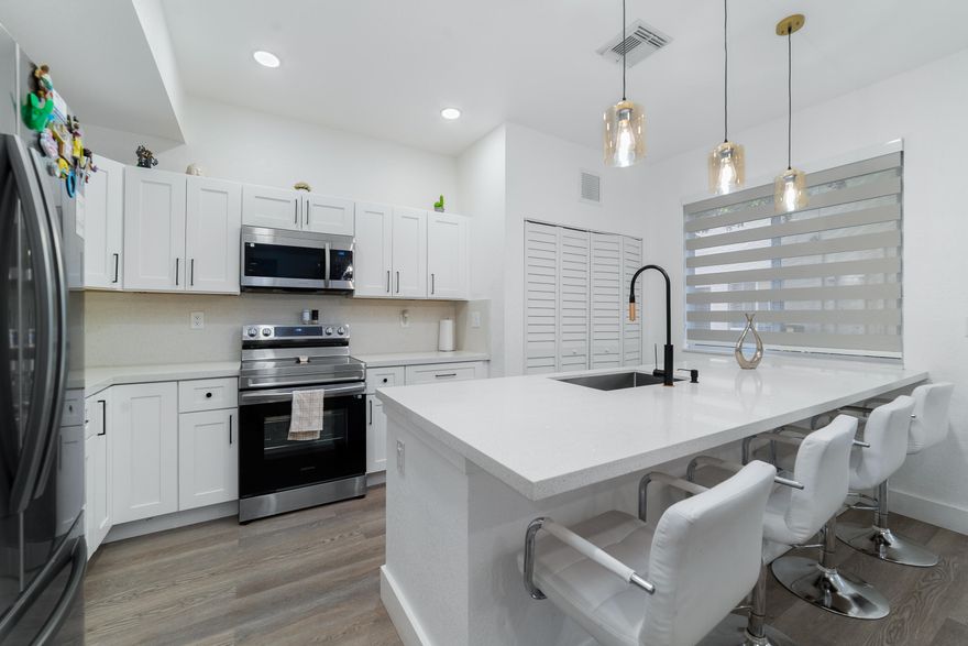 BEST VALUE IN MAJORCA ISLES III - FULLY RENOVATED AND MOVE-IN READY. This beautifully updated 2-story 4BR/2.5BA townhouse offers the perfect combination of space, upgrades, and convenience in a gated Miami Gardens community.  Step inside to a bright, open layout featuring brand-new laminate flooring throughout and a completely renovated kitchen with modern cabinetry, granite countertops, and stainless steel appliances. All bathrooms have been fully updated, and a new washer and dryer add to the turnkey appeal.  Upstairs, you'll find four spacious bedrooms, while the first floor offers a convenient half bath for guests. Enjoy a one-car garage plus additional parking for two vehicles on a private brick driveway. Prime location near Turnpike with low HOA and strong community amenities.