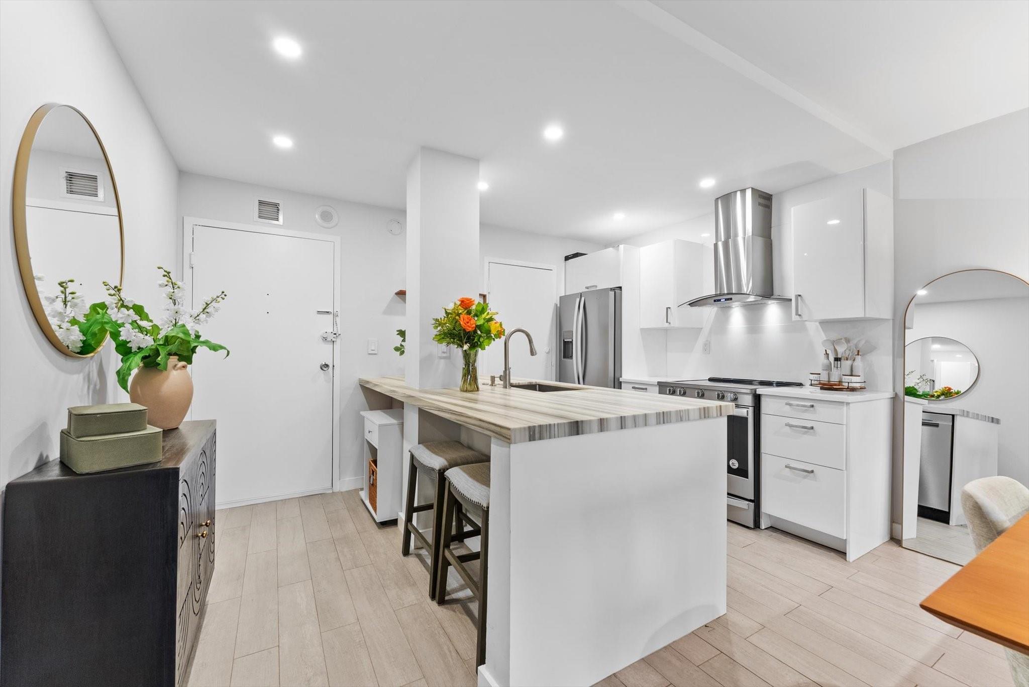Stunning 2-bedroom, 1-bath residence in highly sought-after Victoria Park! Fully renovated with designer finishes, this home features an open kitchen with marble and nano-glass counters, snack bar seating, and premium stainless-steel appliances. The living area is highlighted by a striking porcelain tile feature wall, while the spa-inspired bath boasts a Blue Macauba mosaic shower and marble vanity. Additional upgrades include impact windows and door. Enjoy morning coffee on your east-facing balcony overlooking the sparkling community pool. All just minutes from Las Olas, the beach, fine dining, shopping, and more!